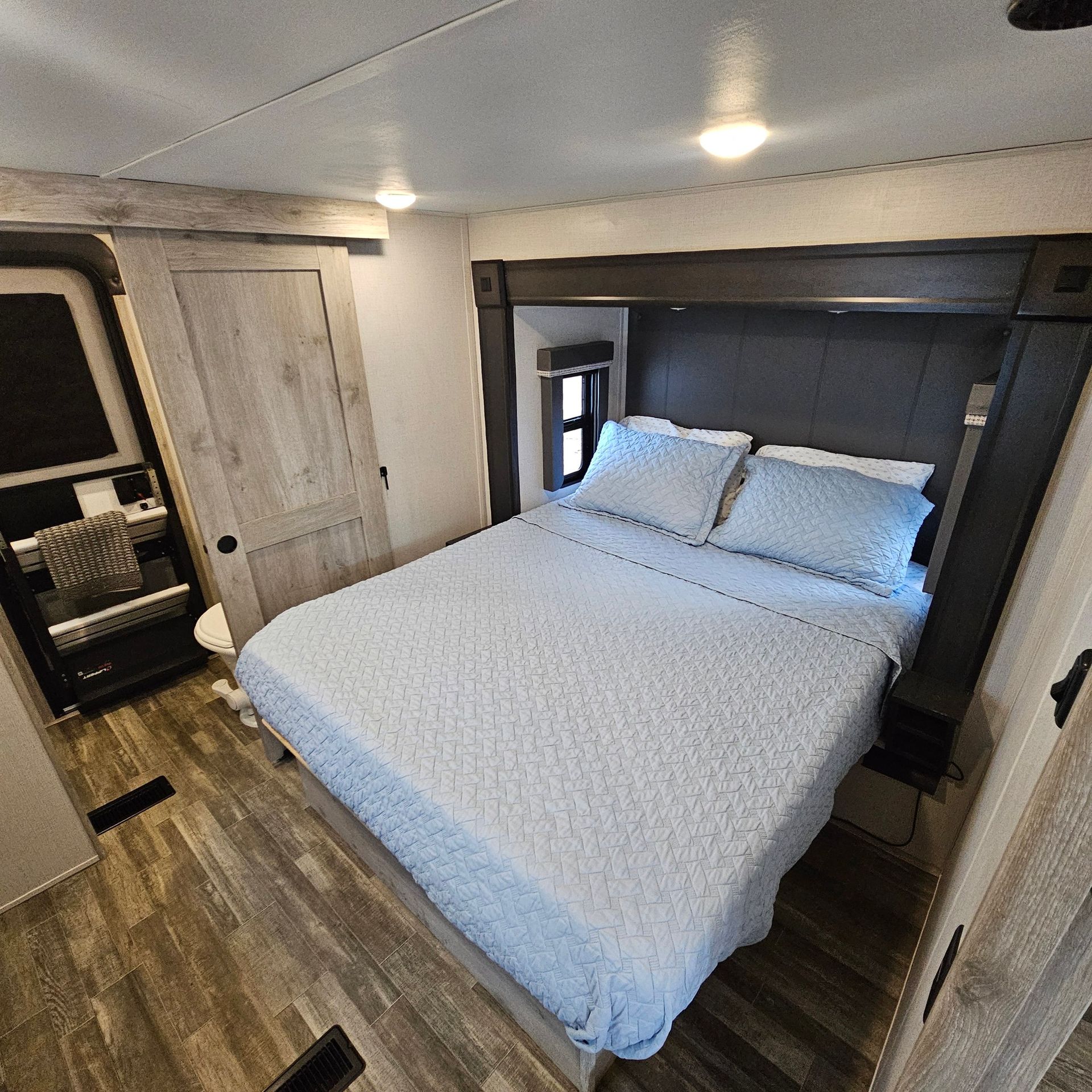 A bedroom with a king size bed and a window