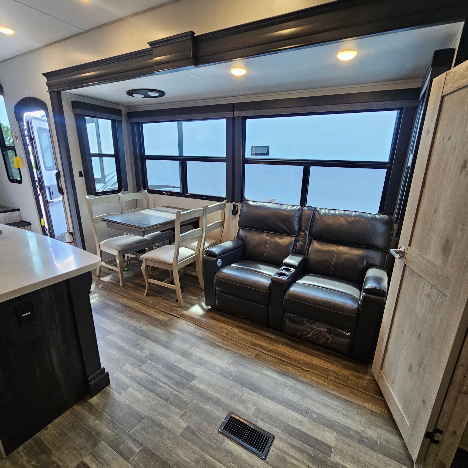 A living room with a couch, chairs and a table