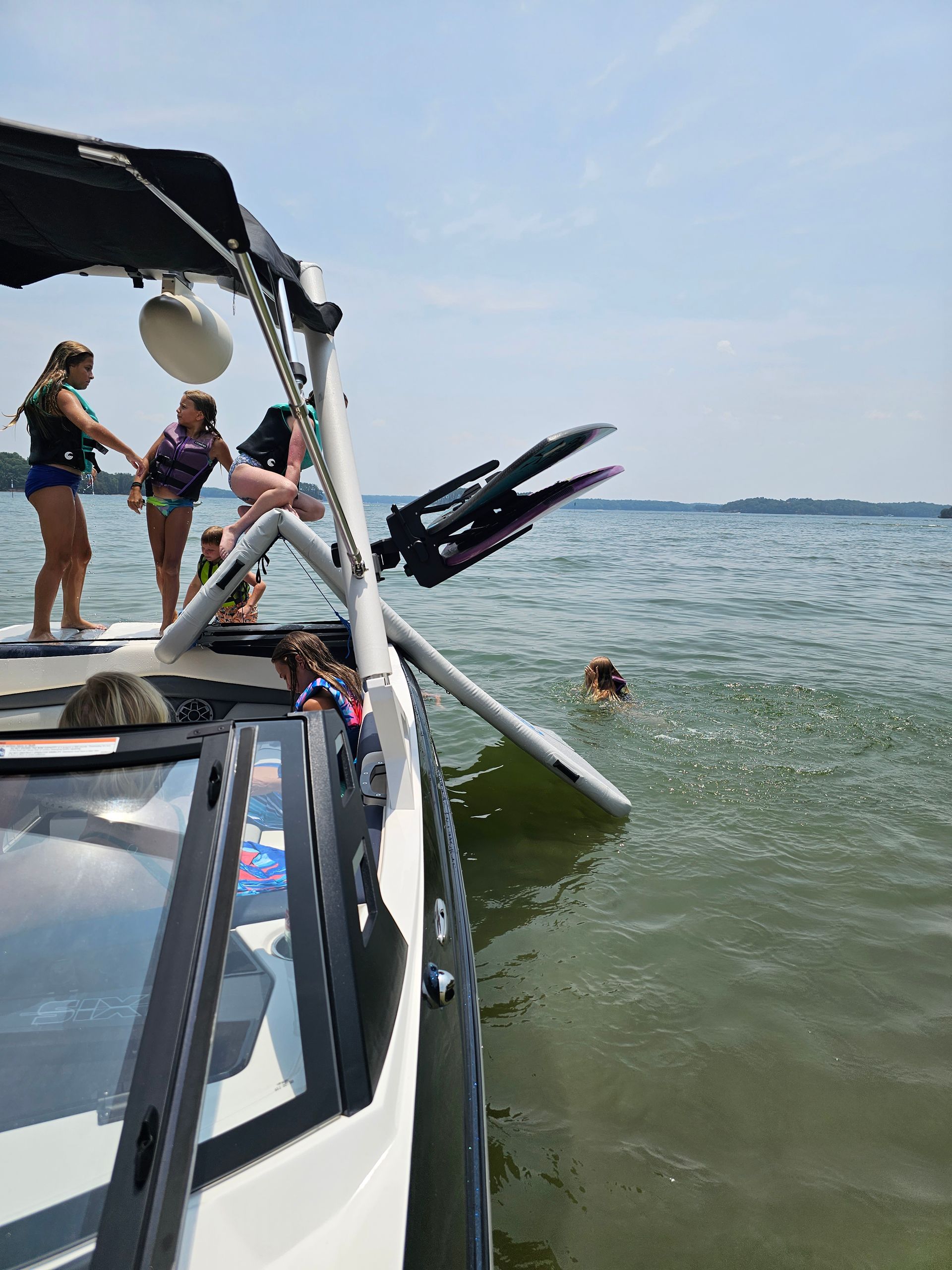 A group of people are on a boat in the water.