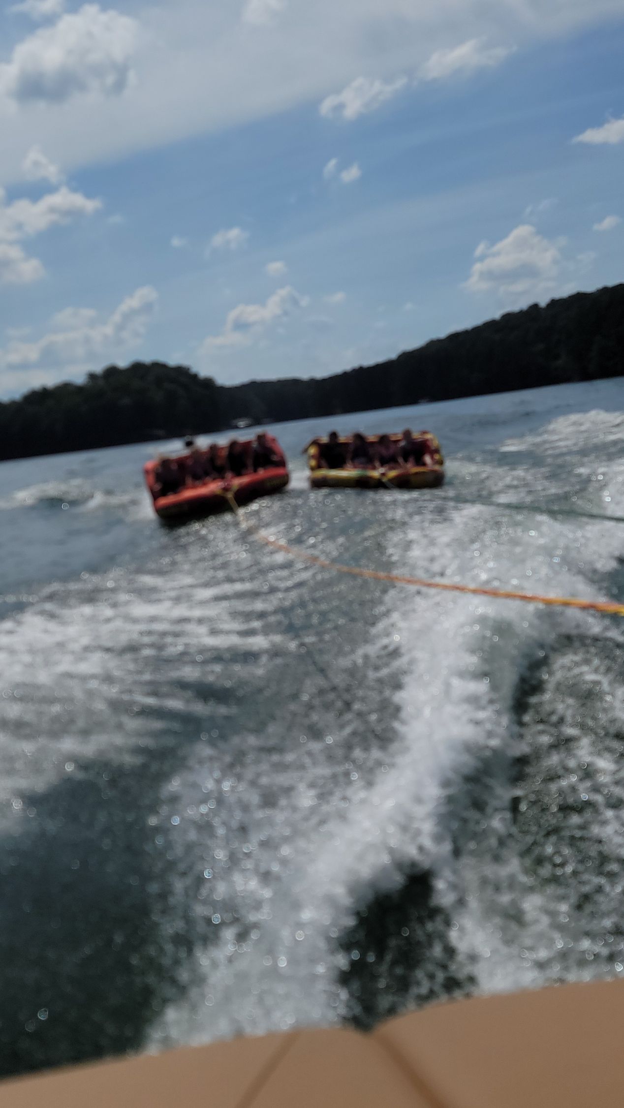 A group of people are being towed by a boat on a lake