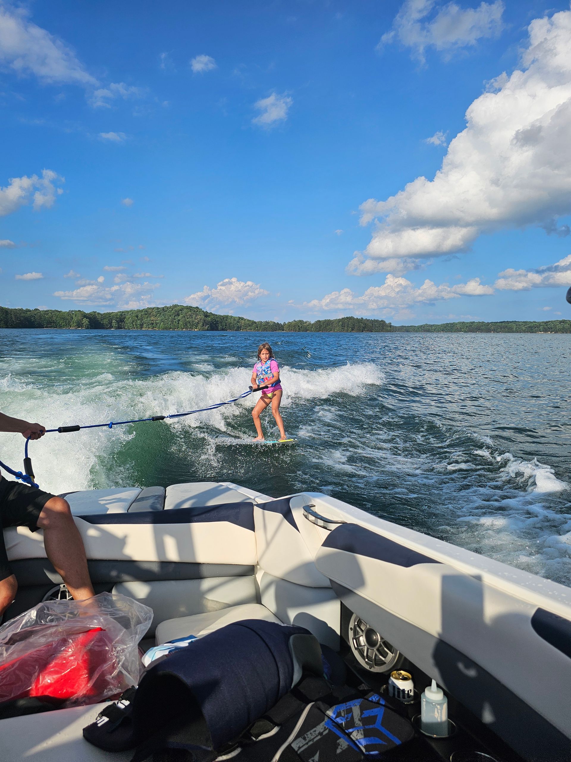 A person is being towed by a boat on a lake