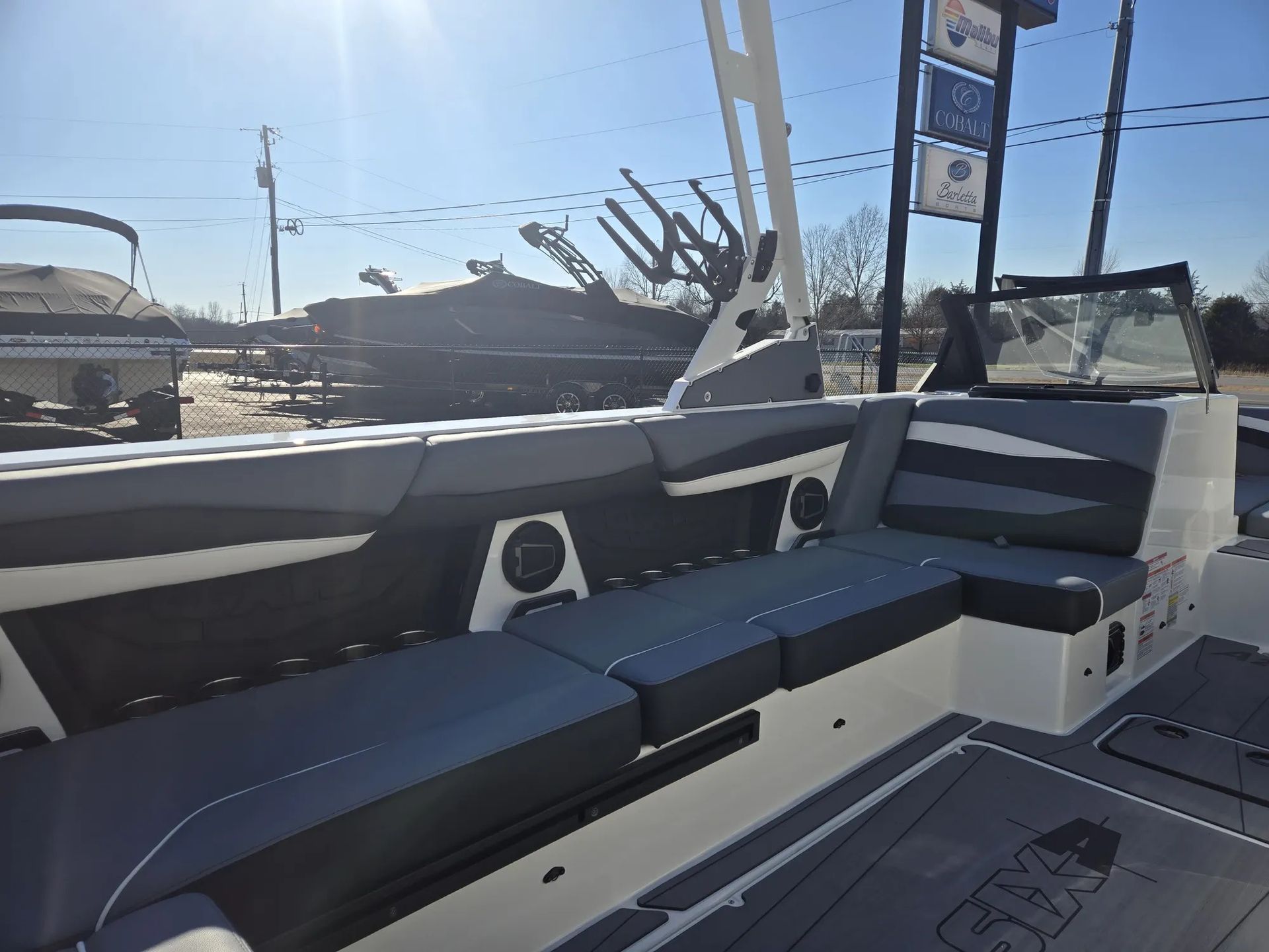 The inside of a boat with a lot of seats and speakers.
