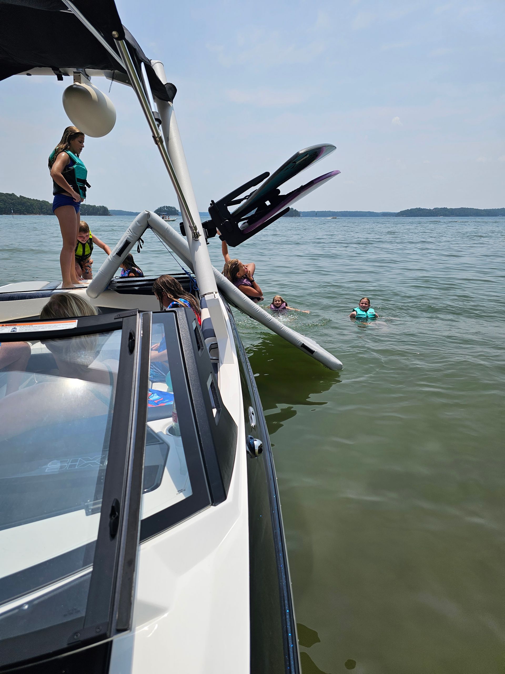 A group of people are riding a raft on a lake.