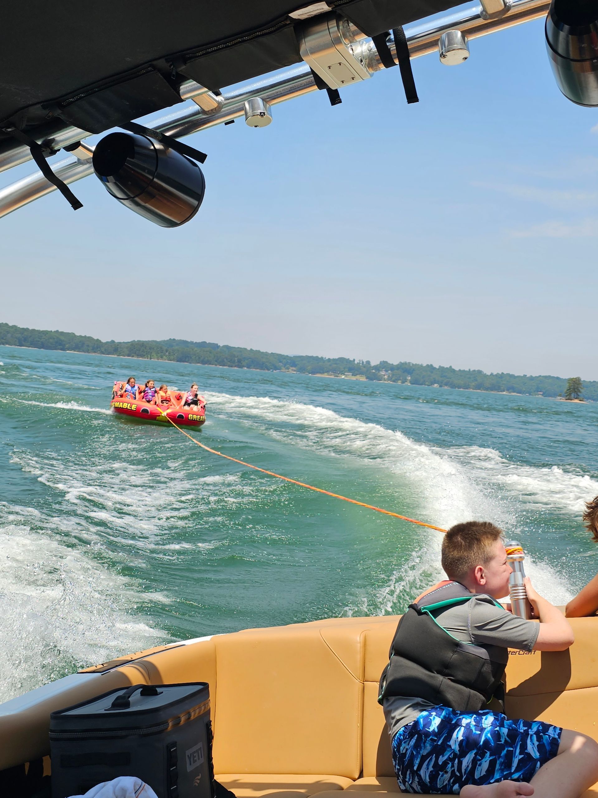 A group of people are on a boat in the water.