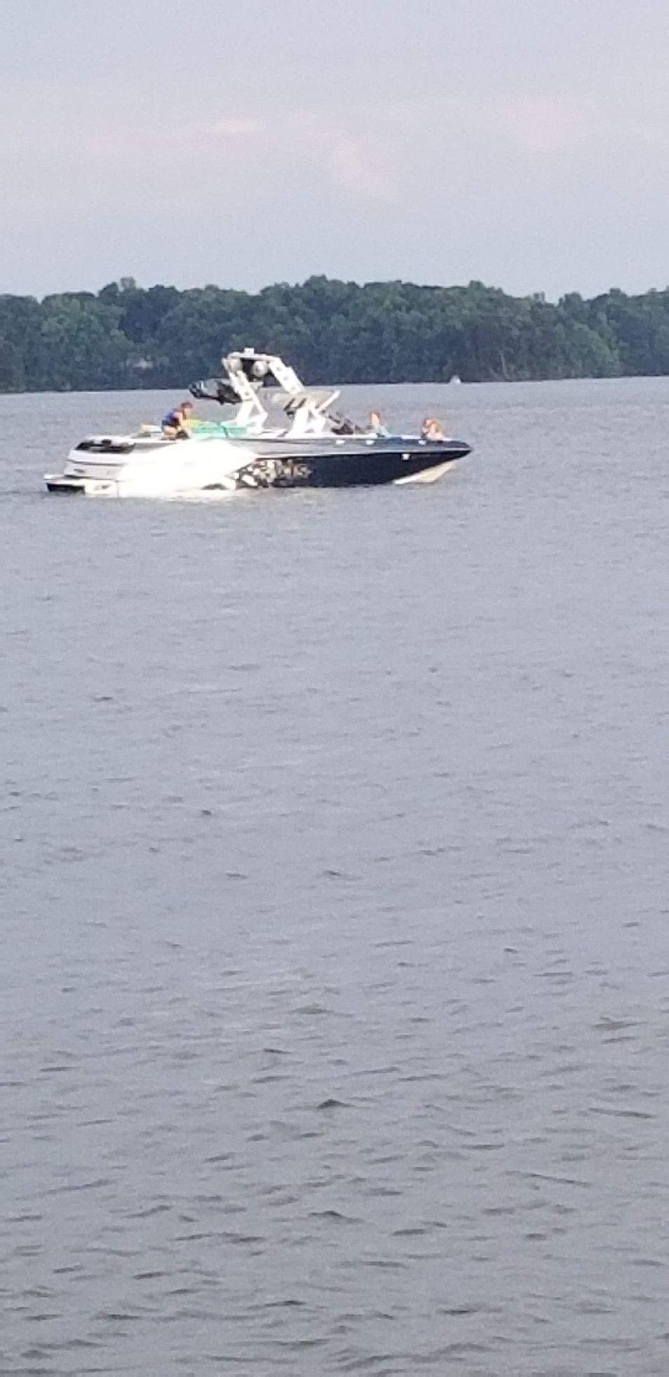 A boat is floating on top of a large body of water.