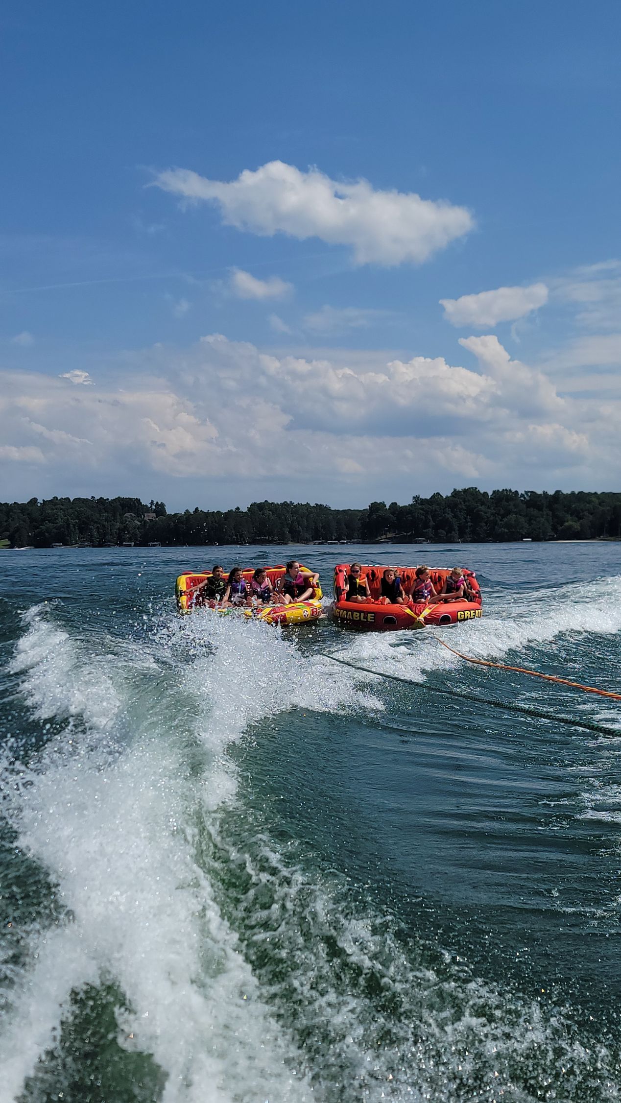 A group of people are riding a raft on a lake.