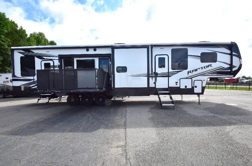 A large white and black RV is parked in a parking lot