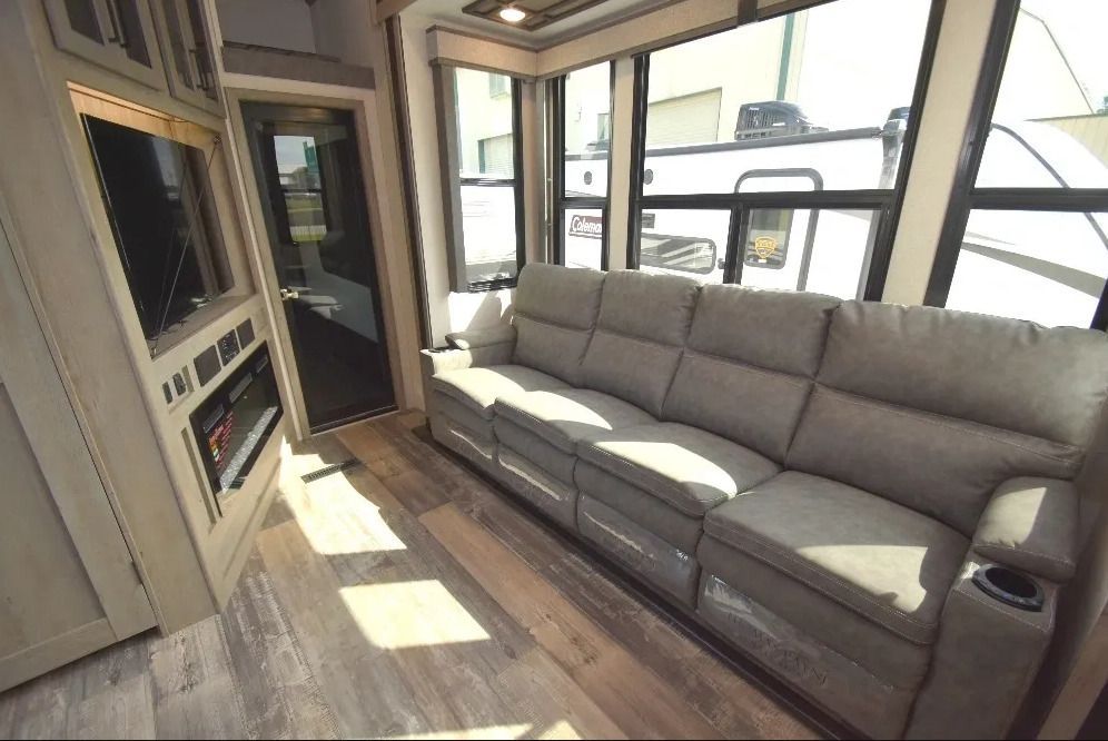 A living room in a RV with a couch and a fireplace