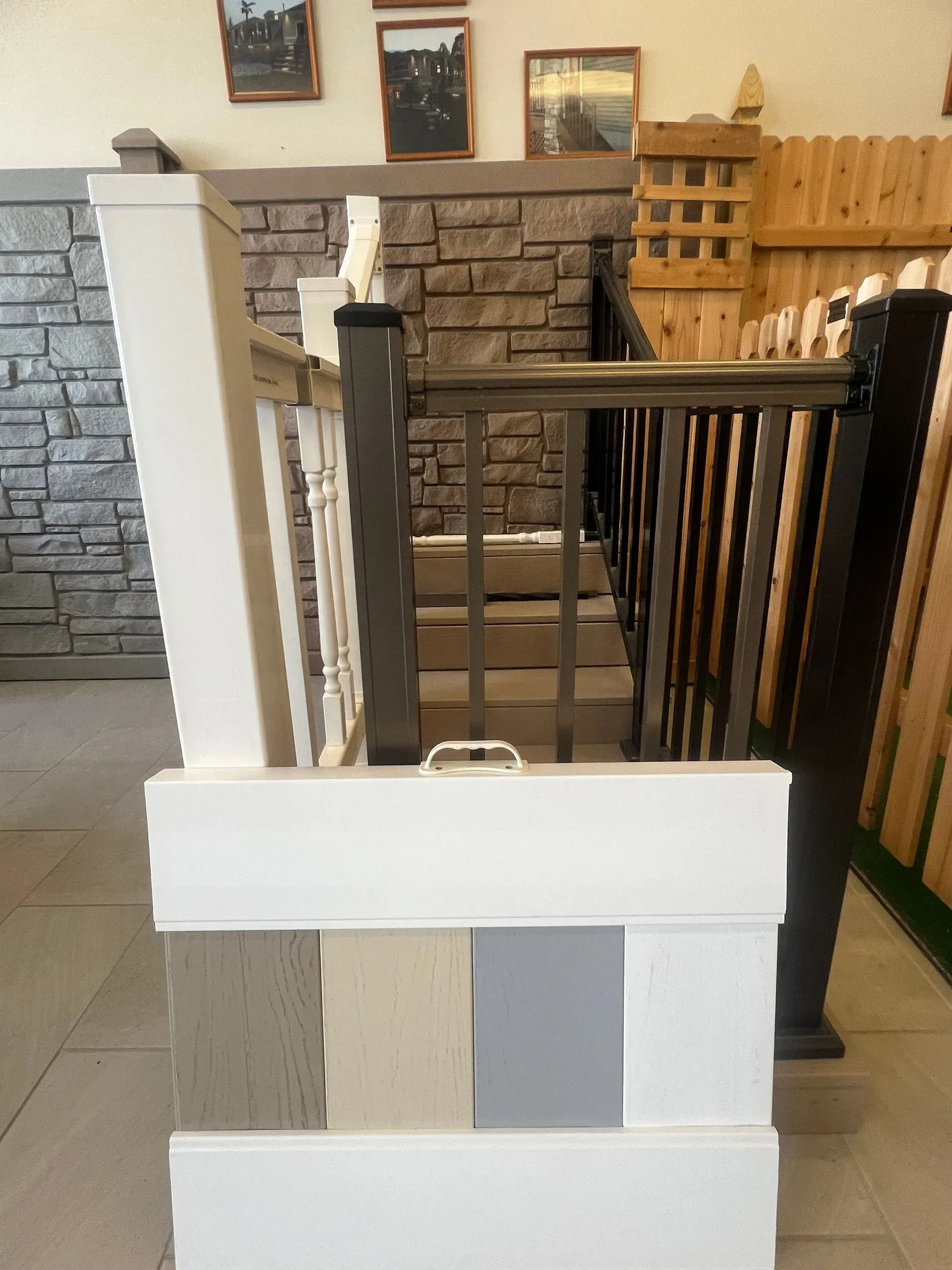 White baby gate in a store aisle beside black and white stair railings and a stone wall