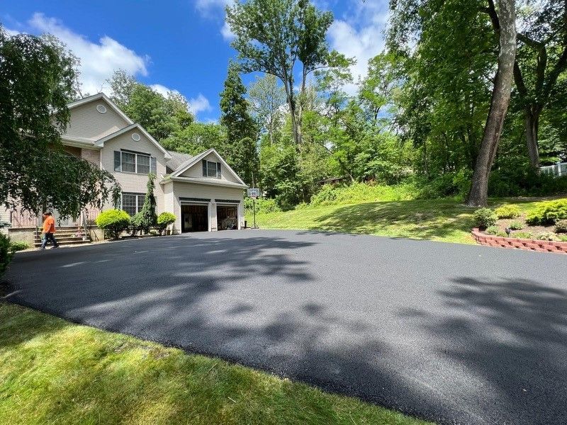 A large house with a large driveway in front of it