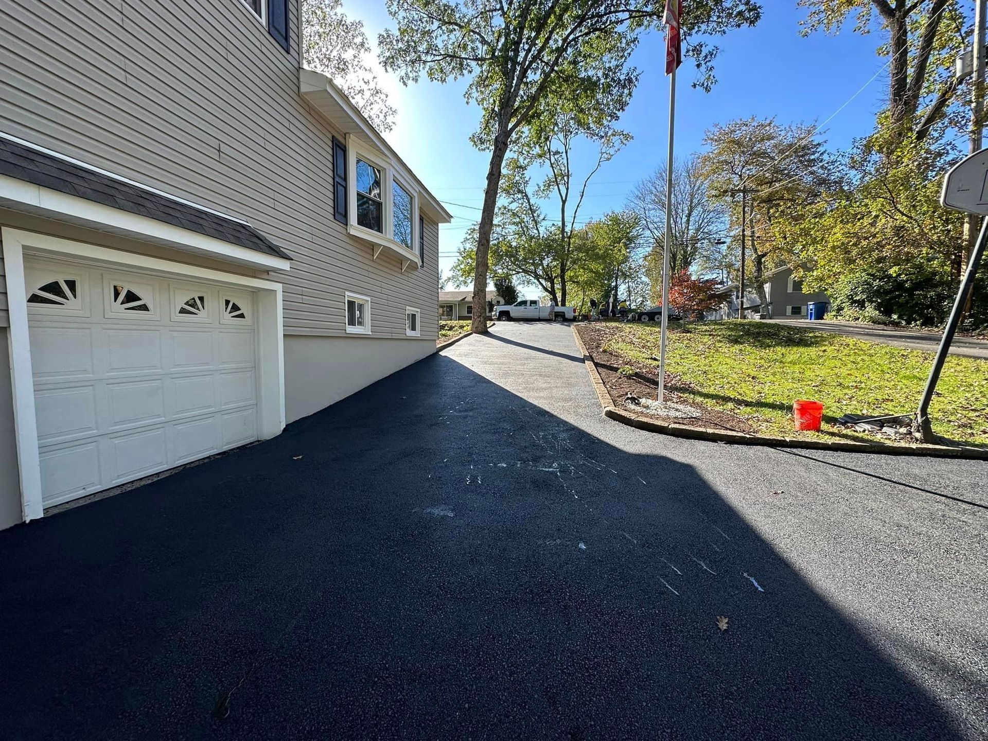 A house with a garage and a driveway leading to it.