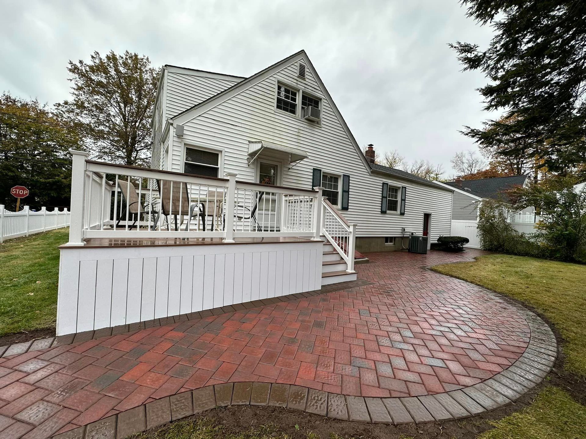 A white house with a brick walkway leading to it