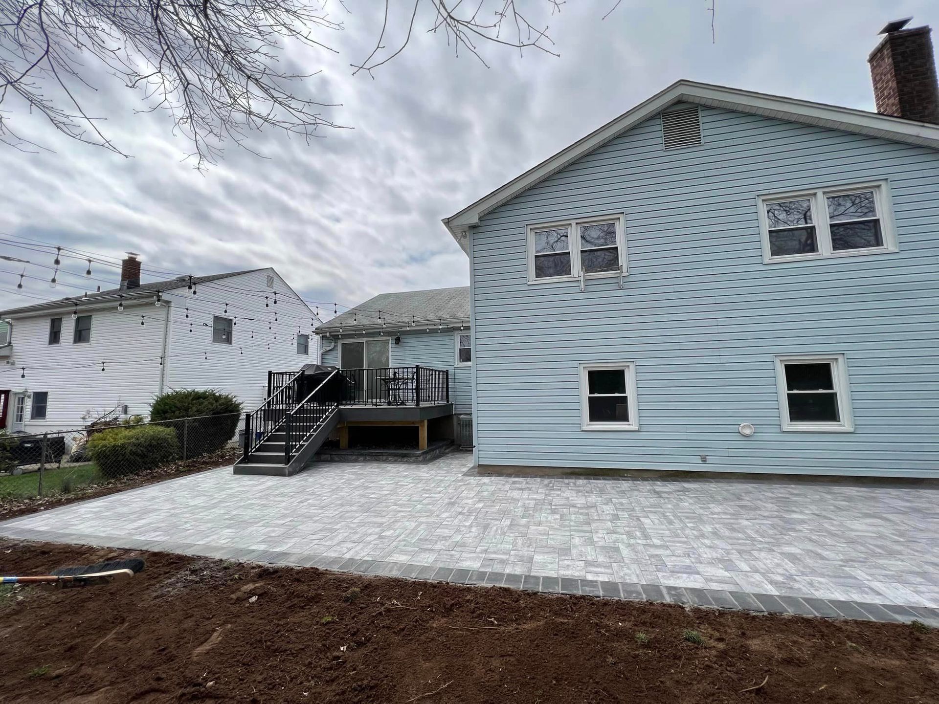 The back of a house with a patio and a deck.