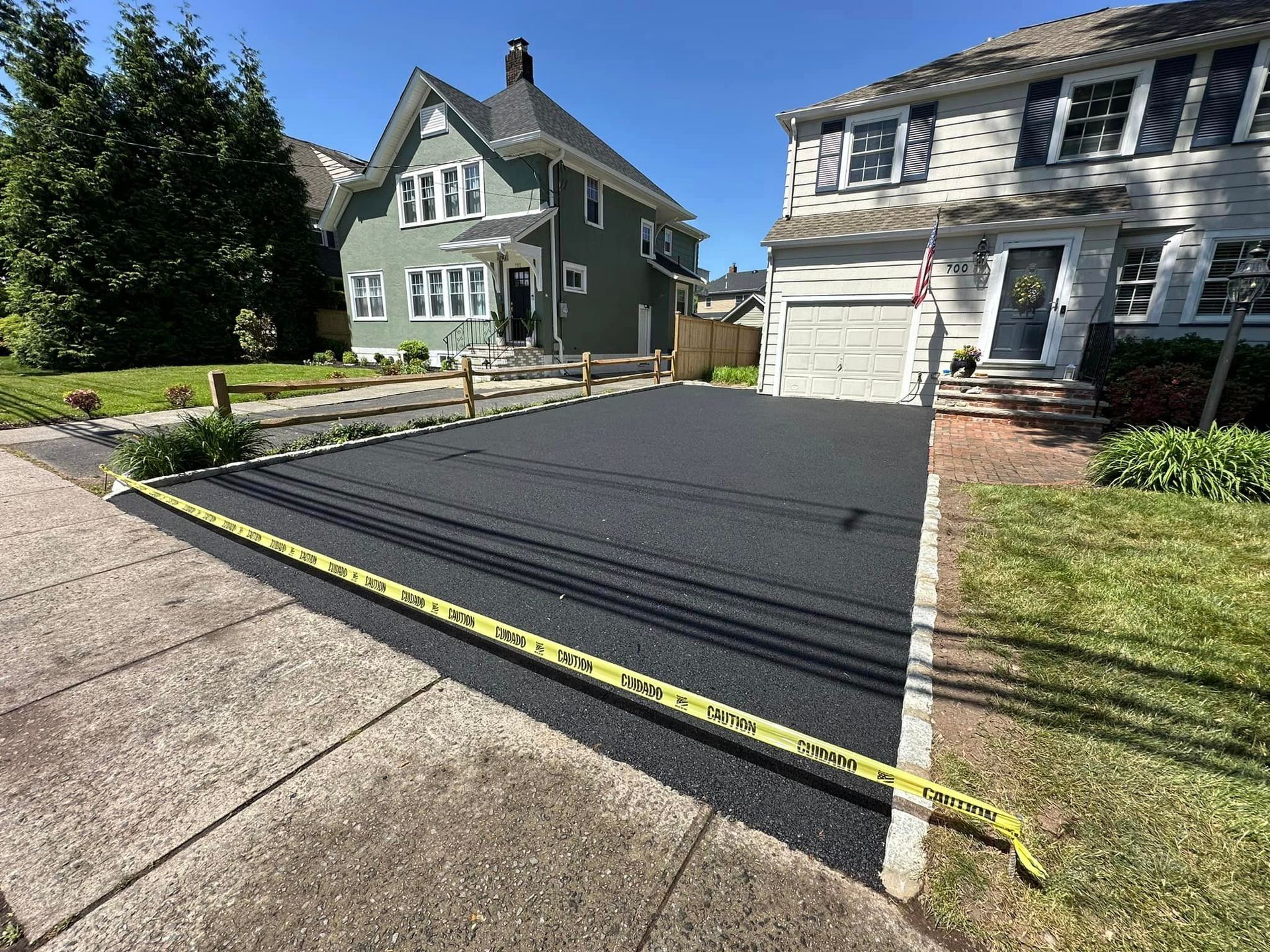 A driveway is being paved in front of a house.