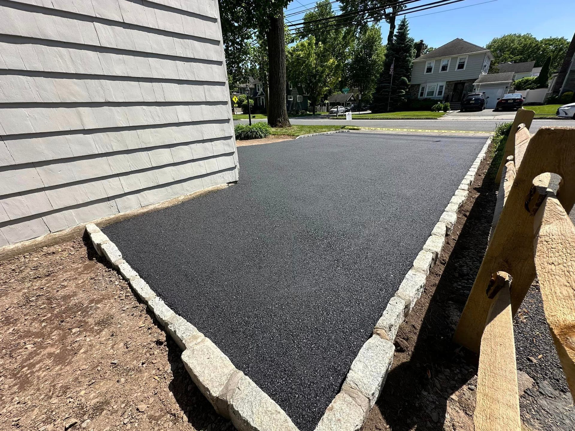 A sidewalk is being built in front of a house.