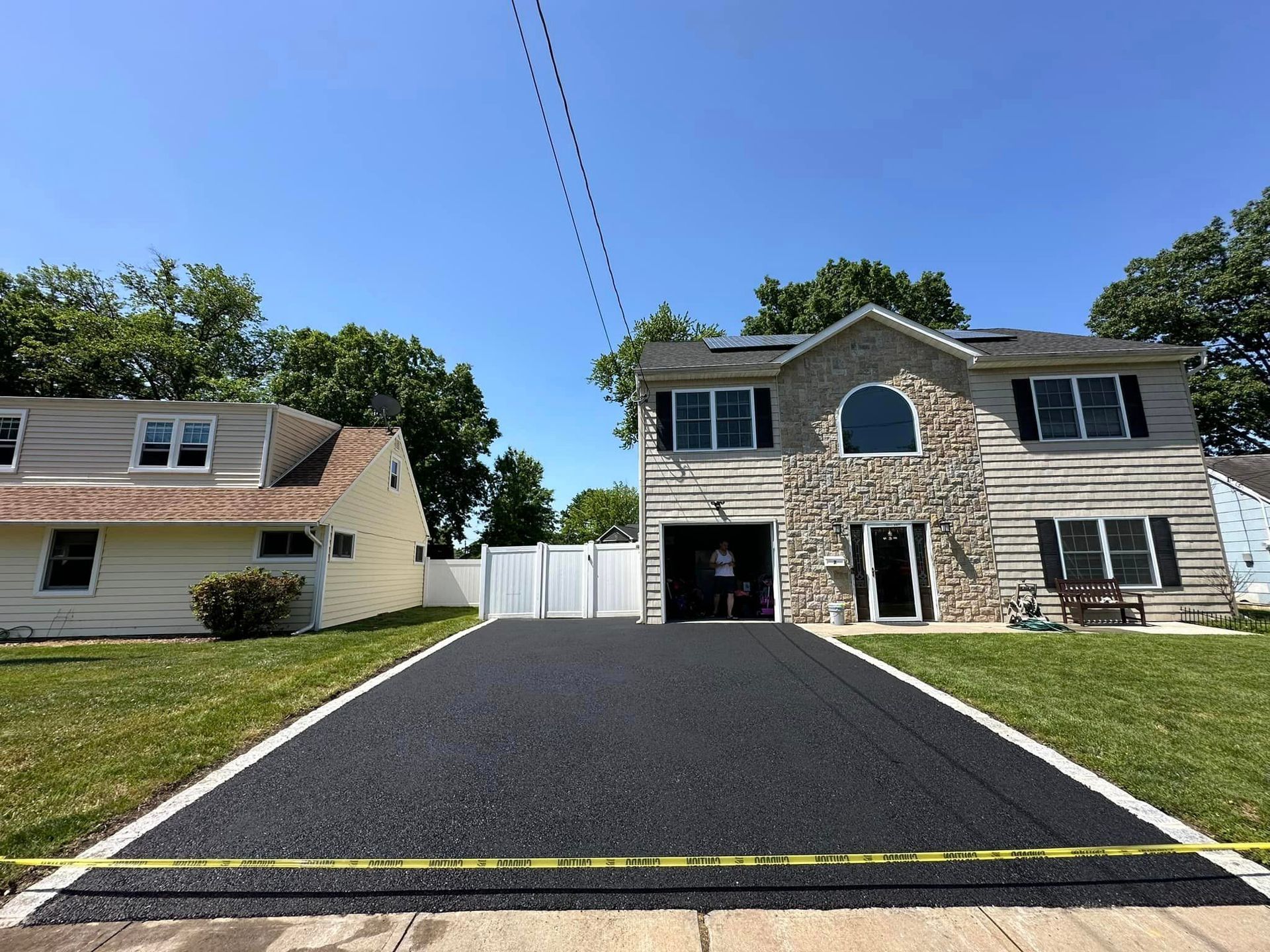 A large house with a large driveway in front of it.