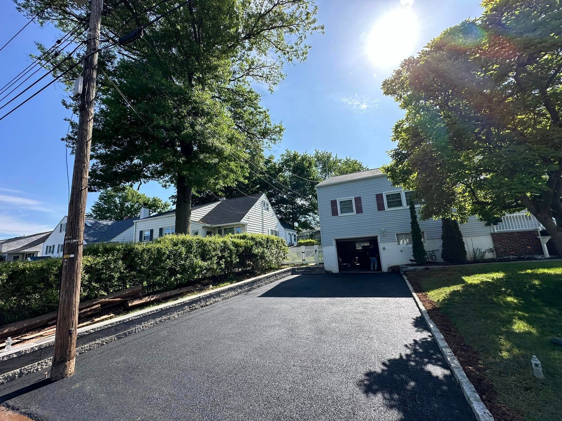 A driveway leading to a house on a sunny day