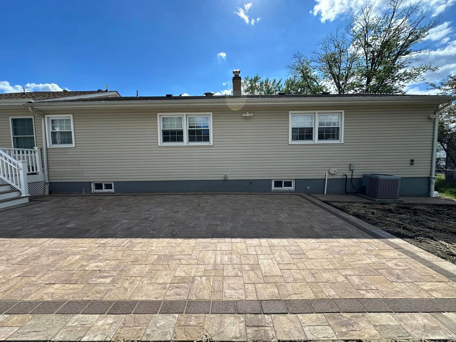 A house with a brick driveway in front of it