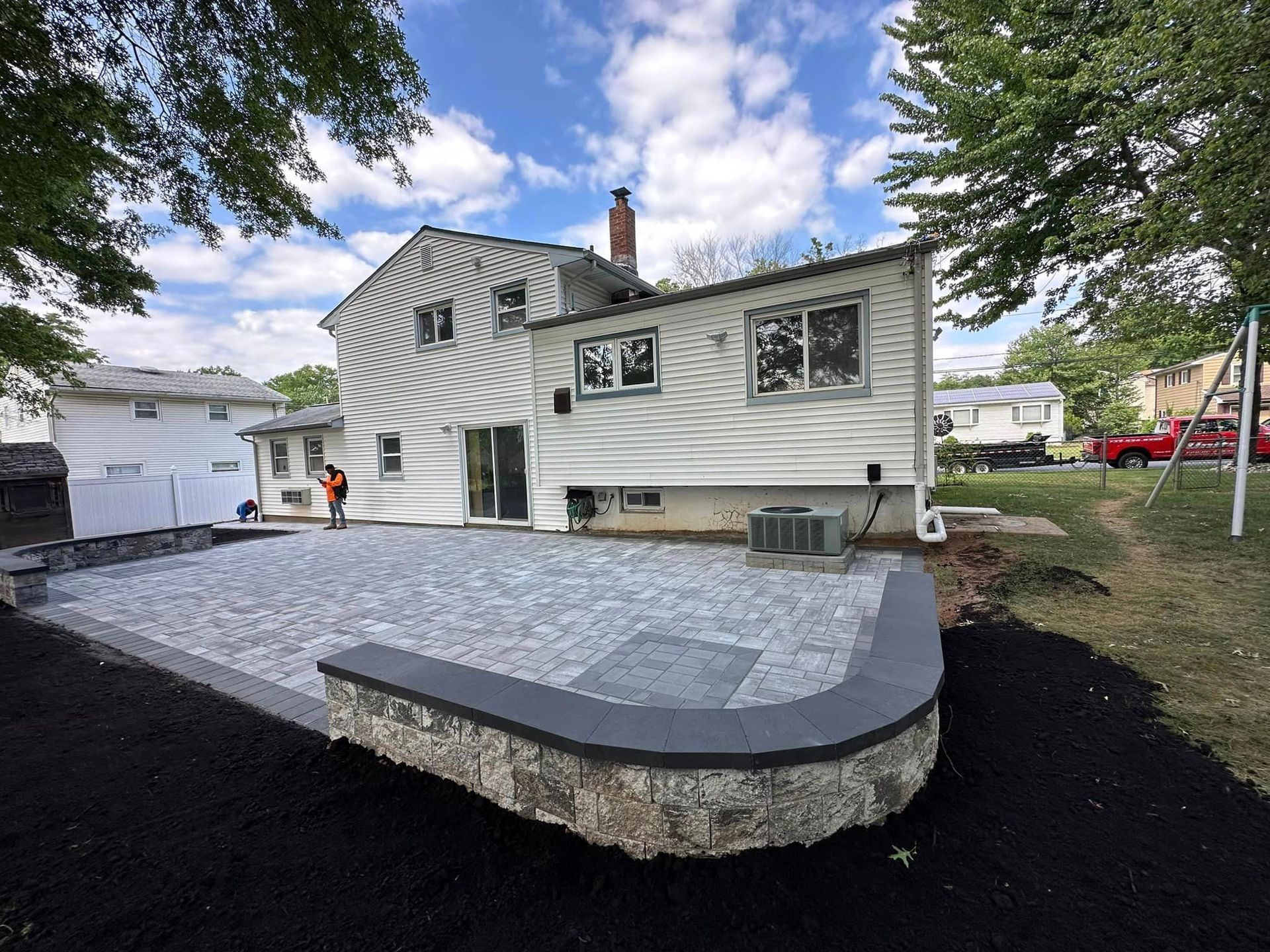 A large white house with a patio in front of it.