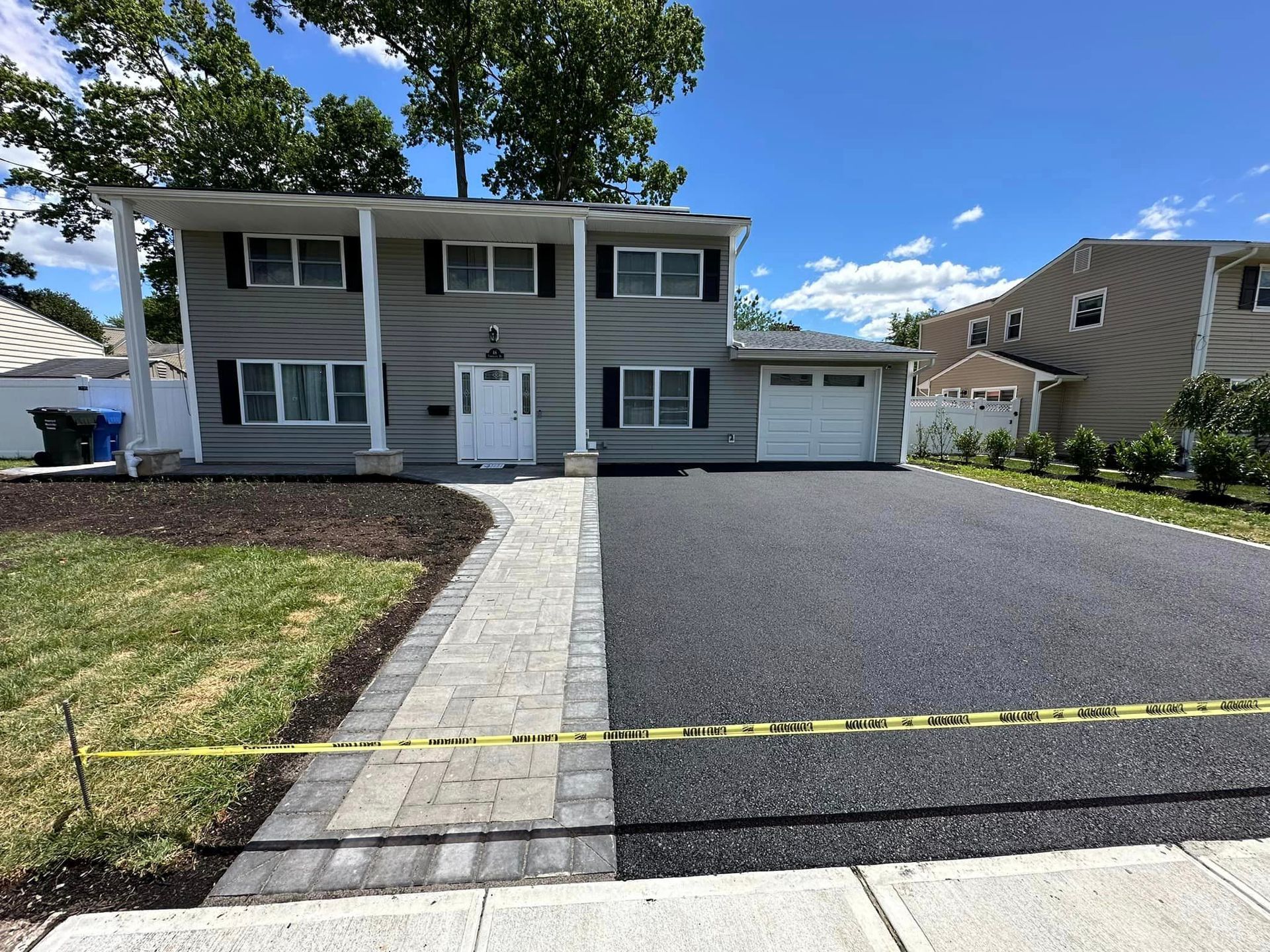 A house with a concrete walkway leading to it