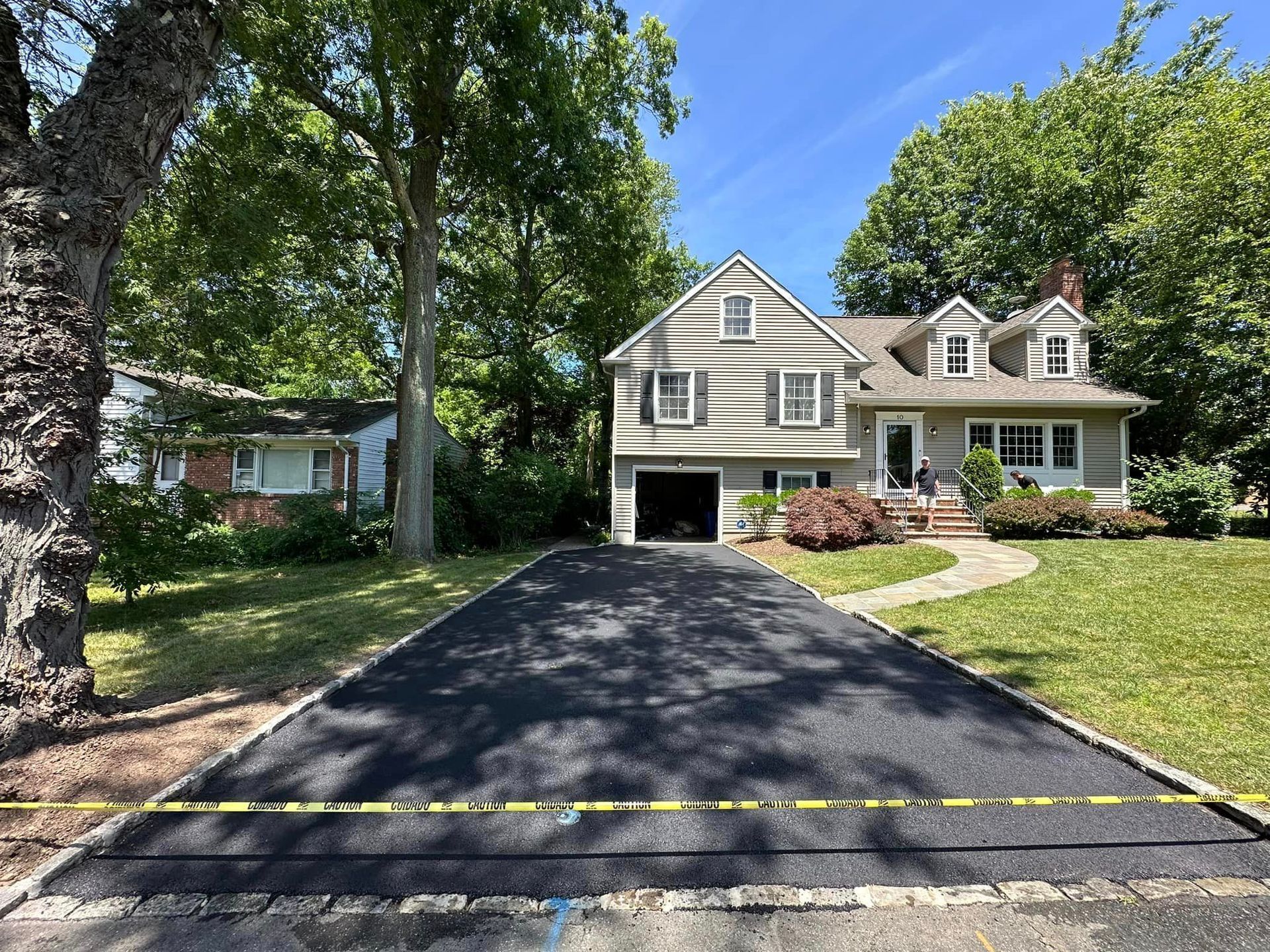 A large house with a large driveway in front of it.
