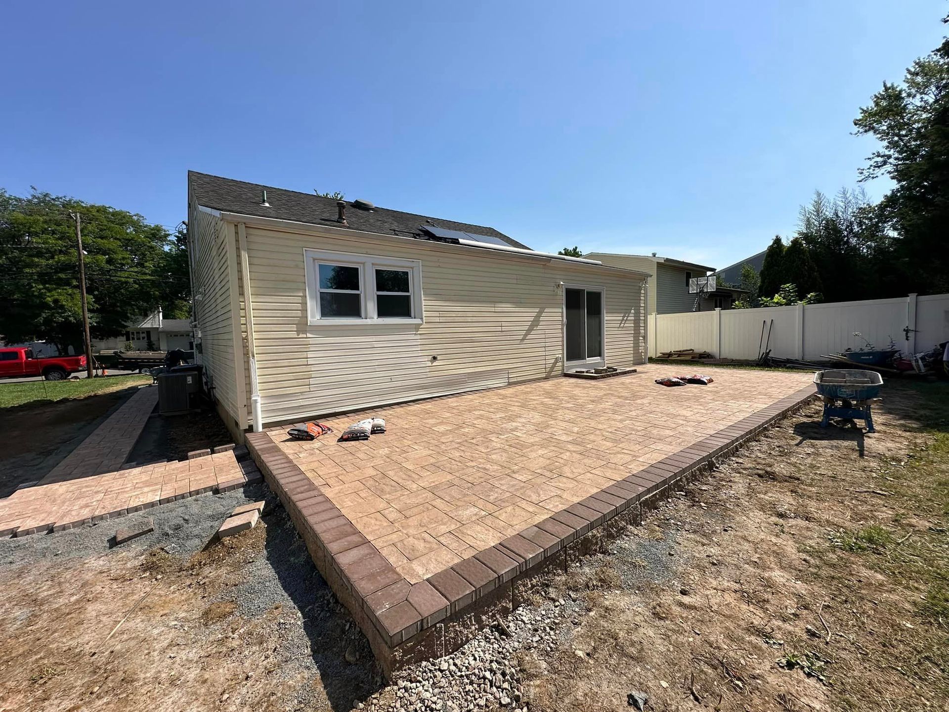 A house with a patio in front of it is being built.