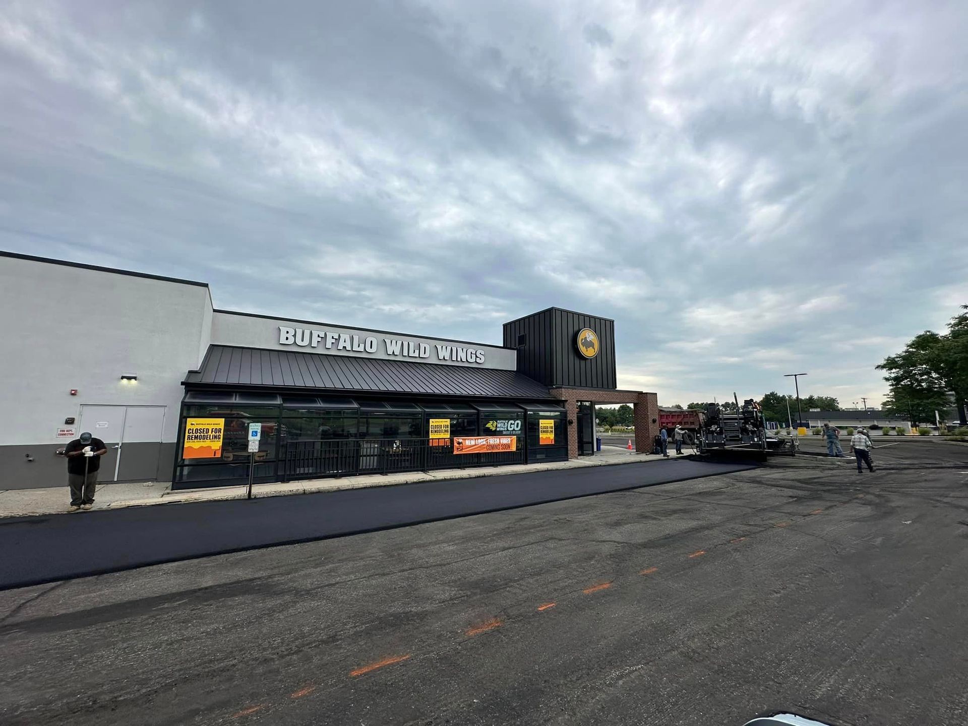 A large building with a lot of parking in front of it.