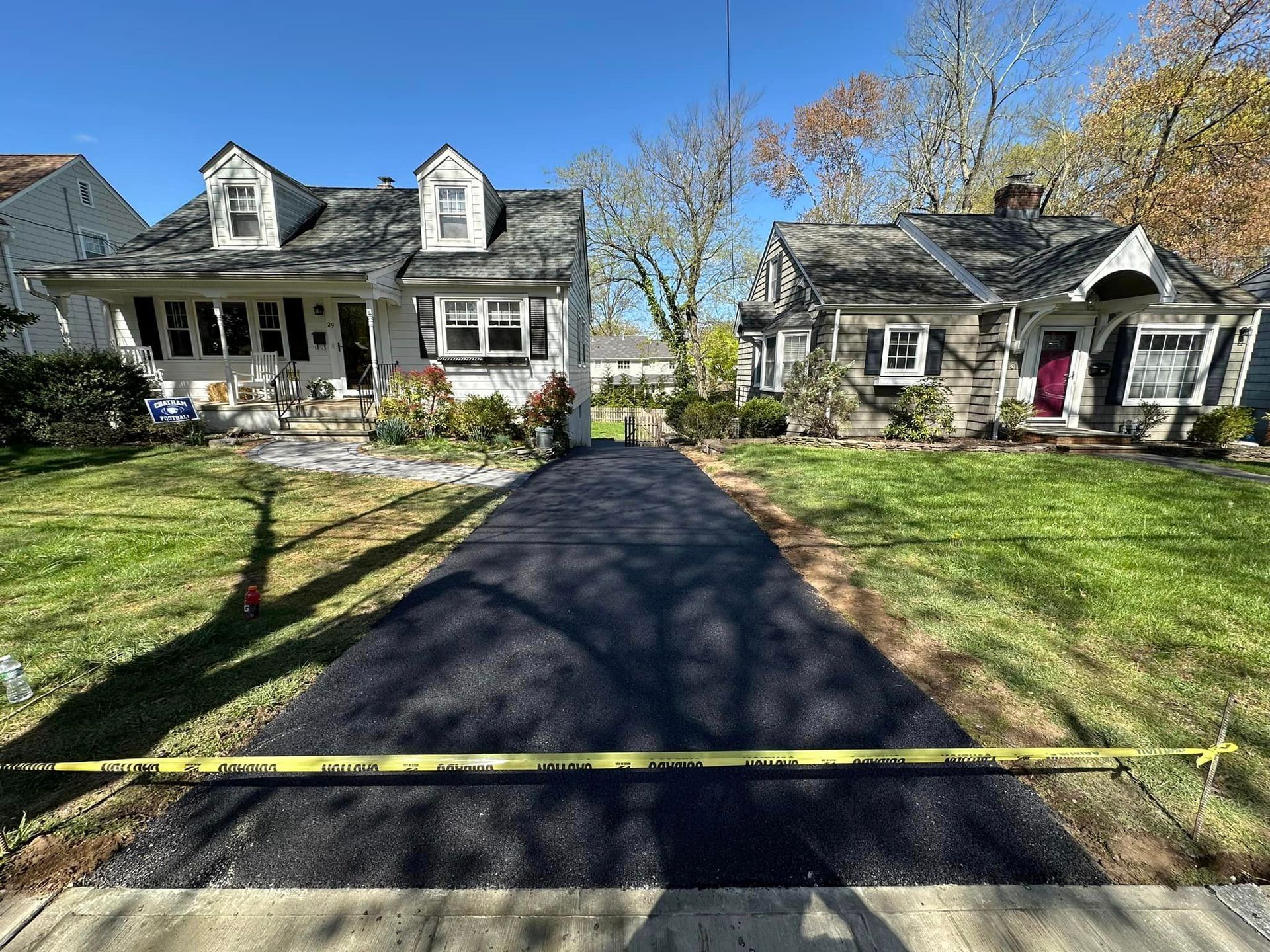 A driveway is being paved in front of a house.