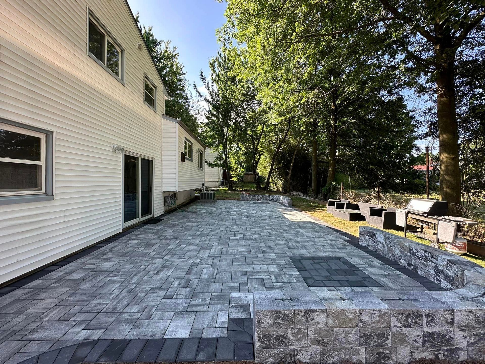 A large white house with a large patio in front of it.