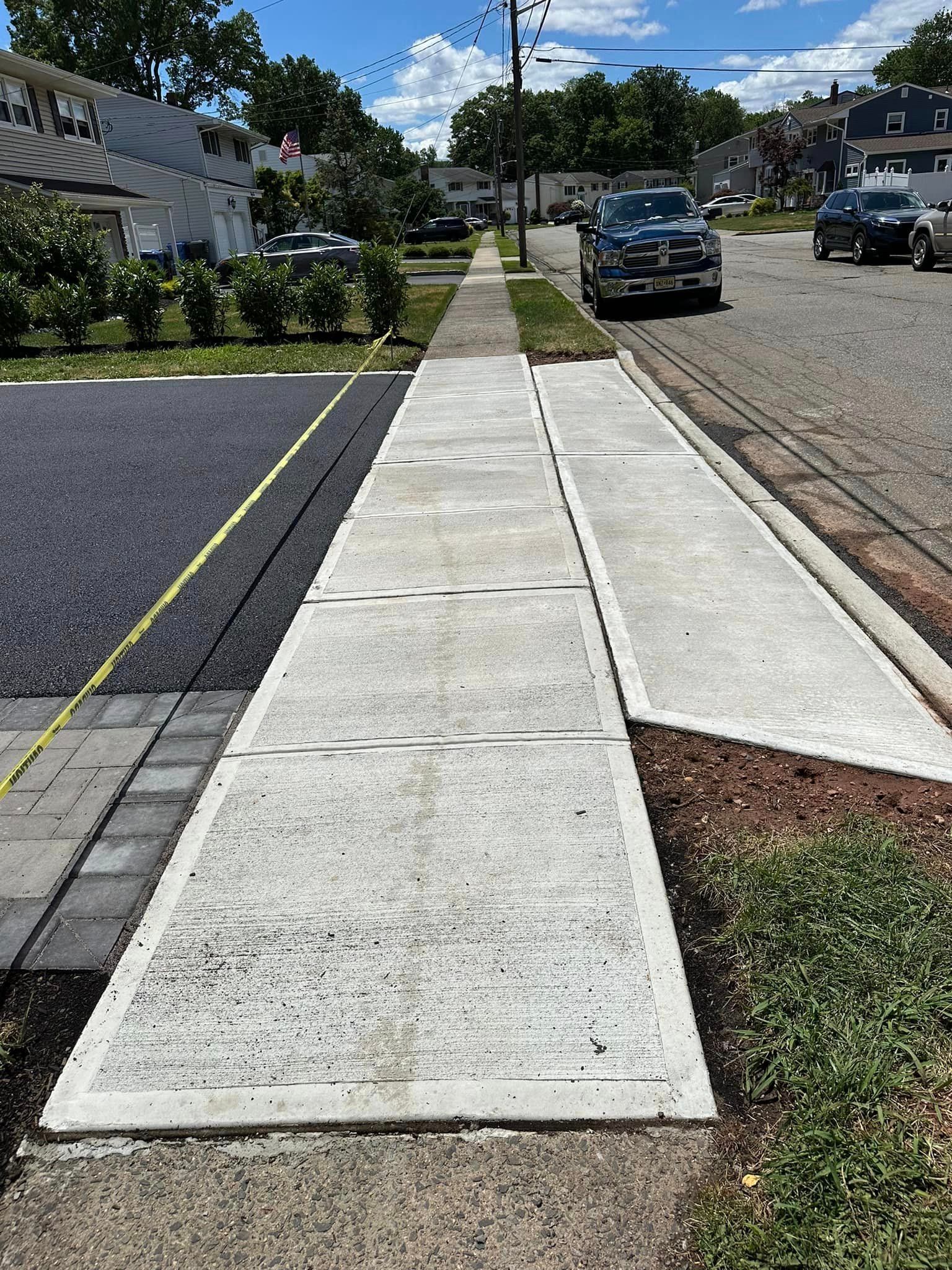 A sidewalk is being built on the side of a street.