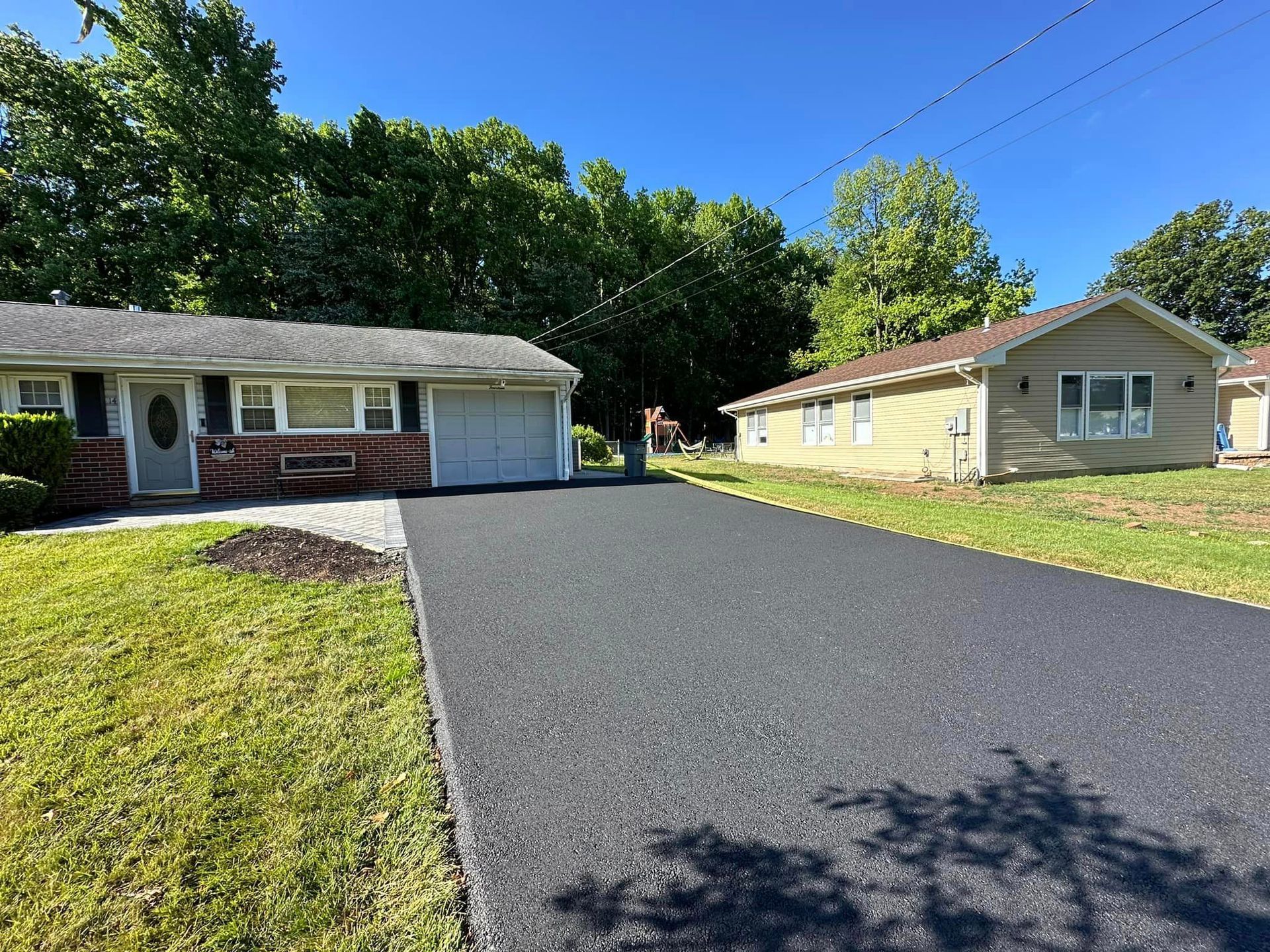 A house with a garage and a driveway in front of it