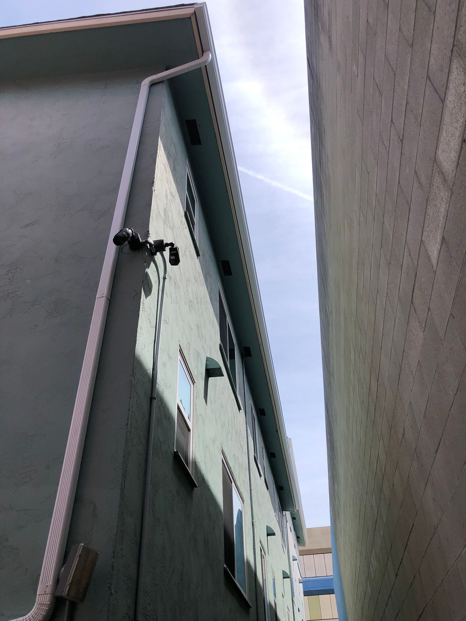 Looking up at a building with a white trim