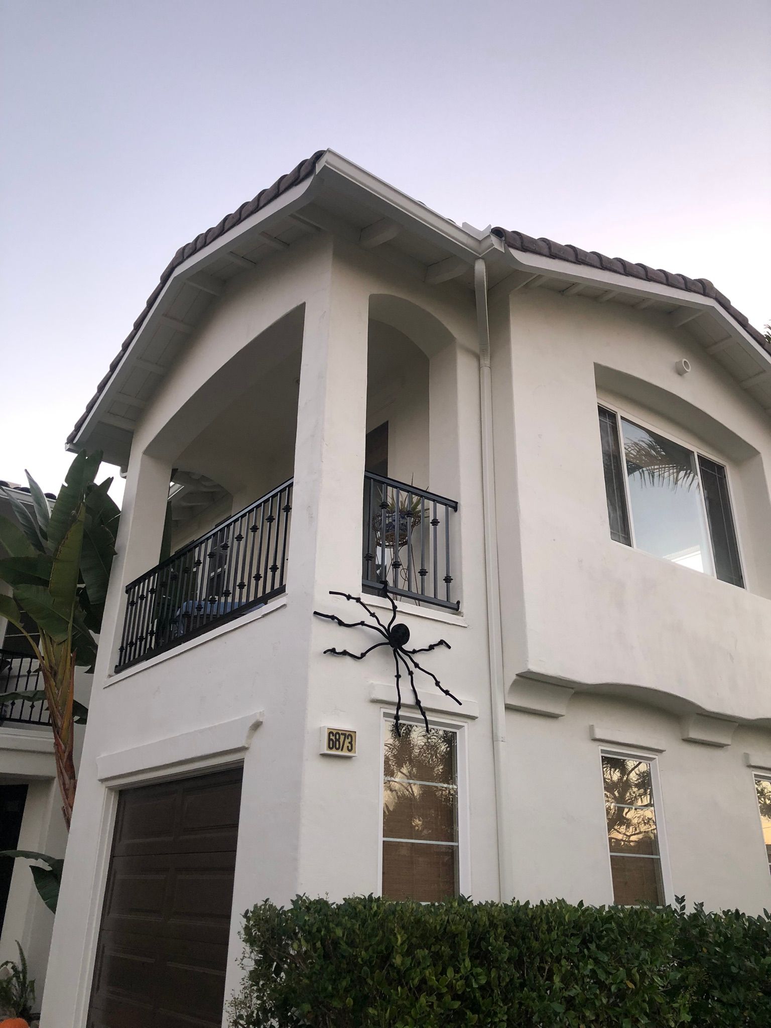 A white house with a spider on the side of it