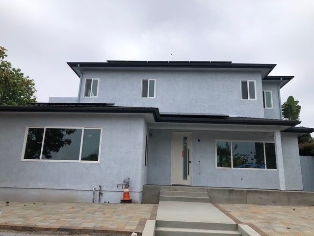 A large house with a lot of windows and stairs