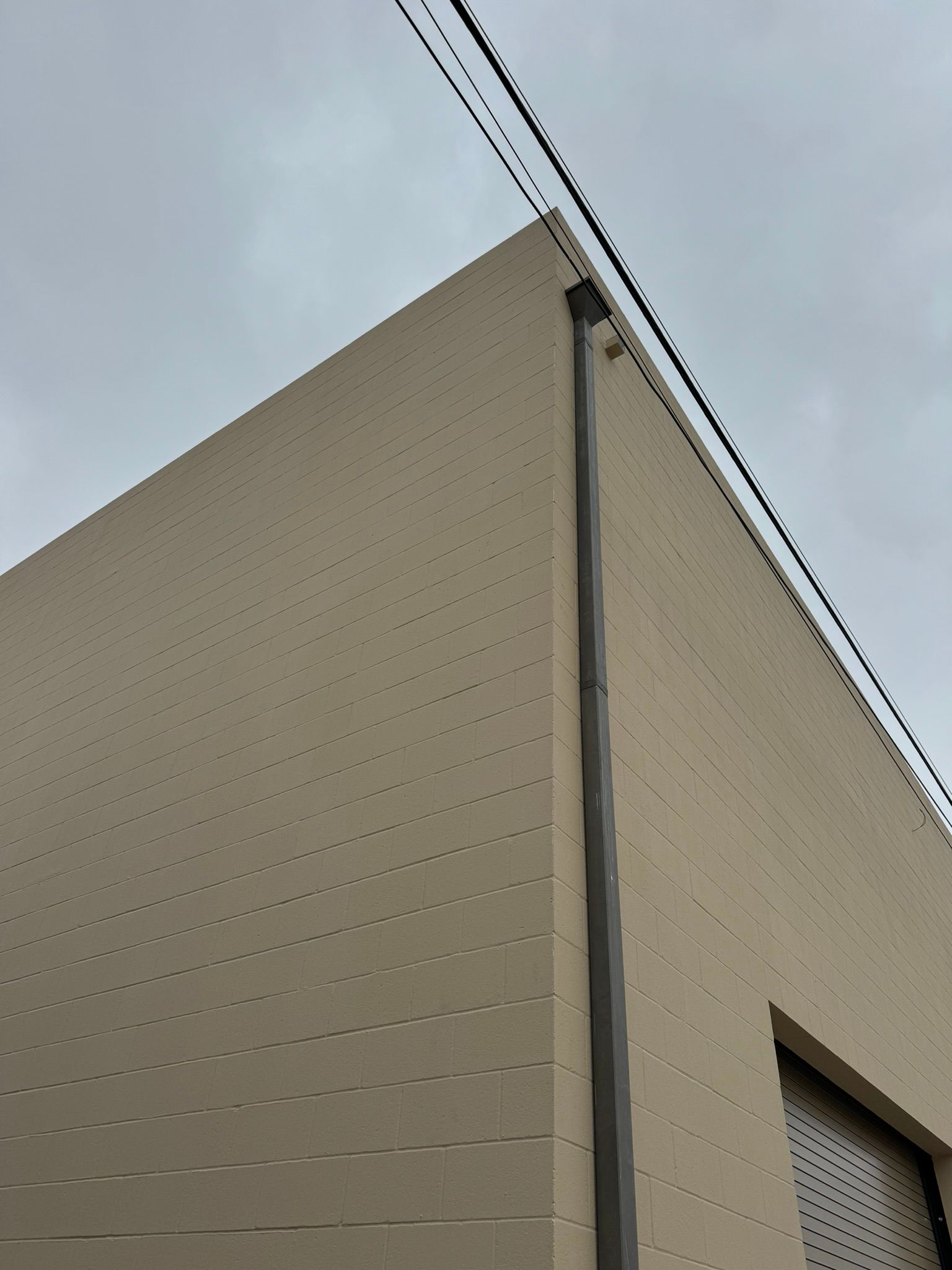 A building with a drainpipe on the side of it.