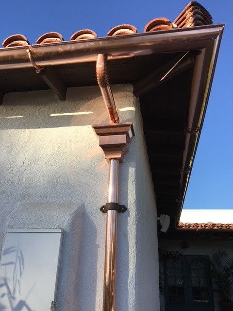 A copper gutter on the side of a building