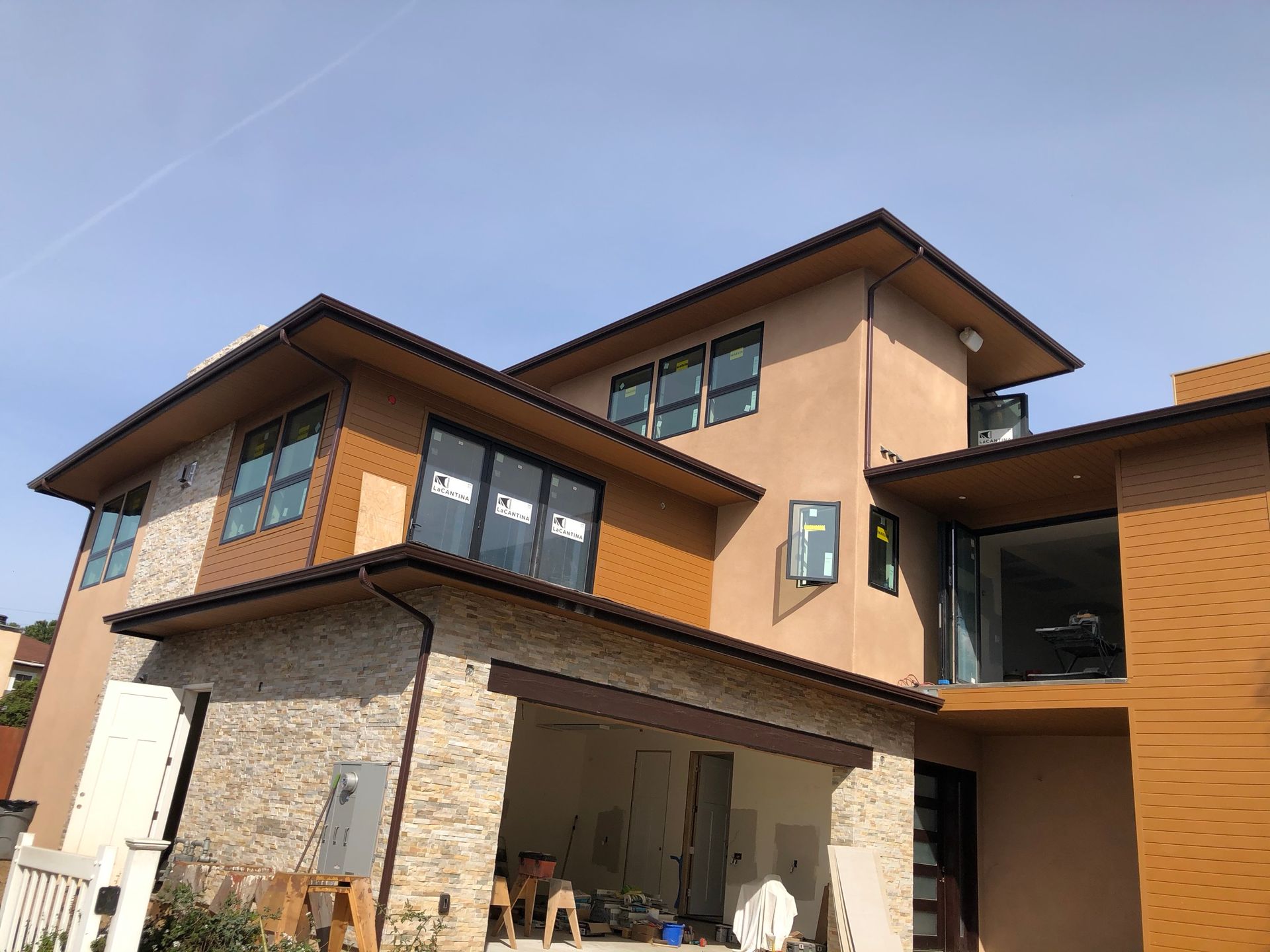 A large house with a lot of windows and a blue sky in the background.