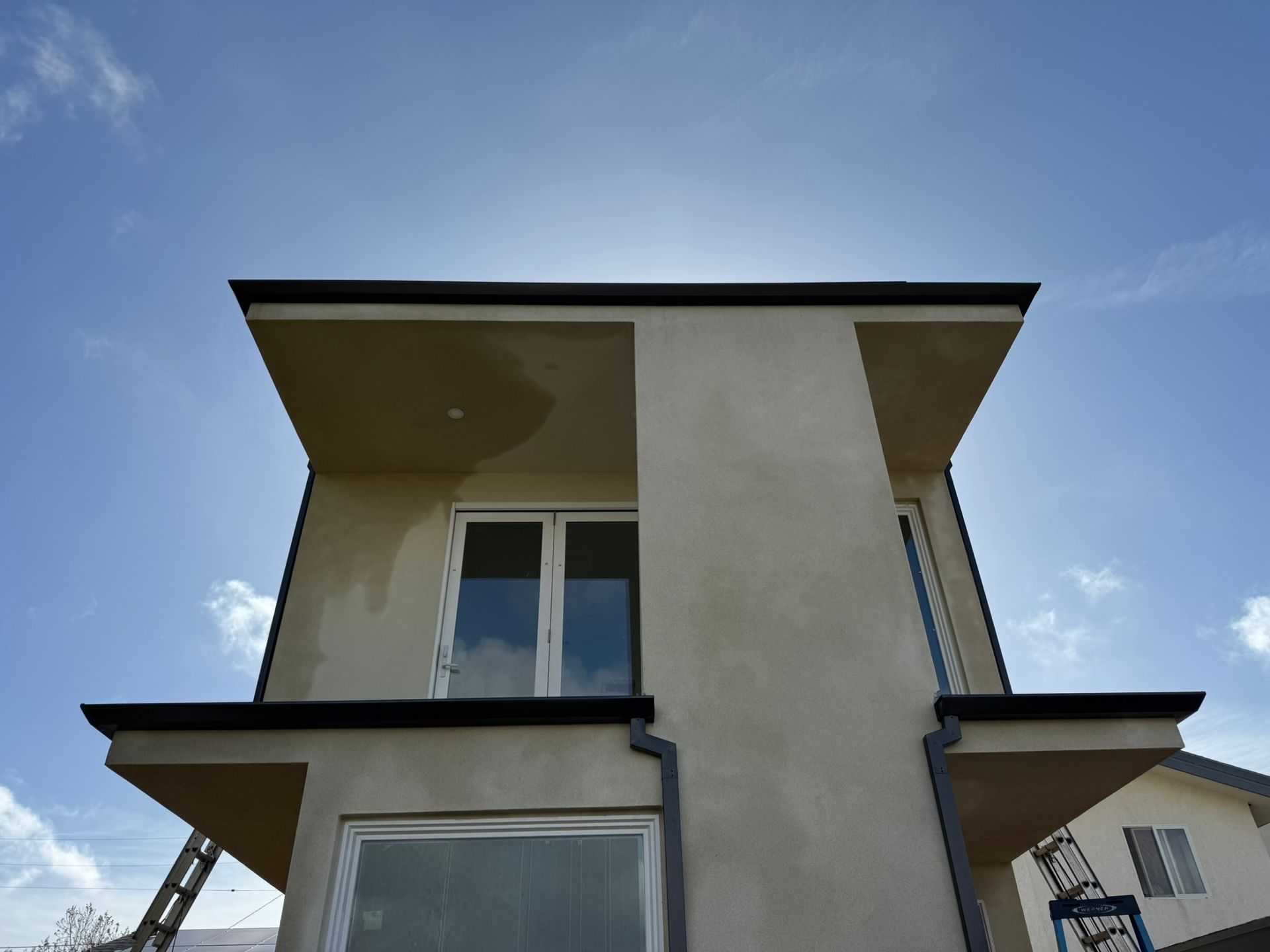 Looking up at a house with a blue sky in the background