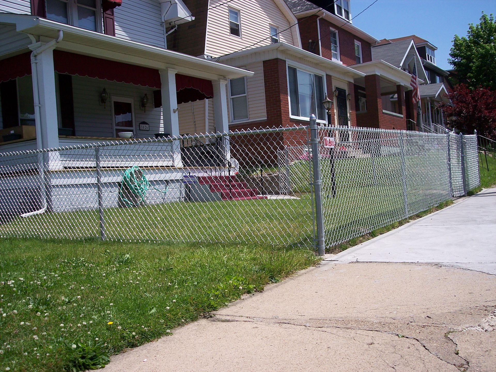 A chain link fence surrounds a row of houses