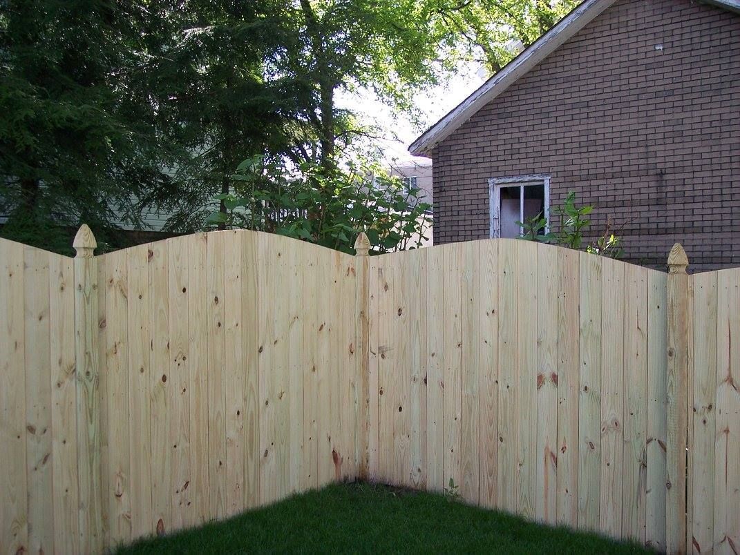 A wooden fence with a house in the background