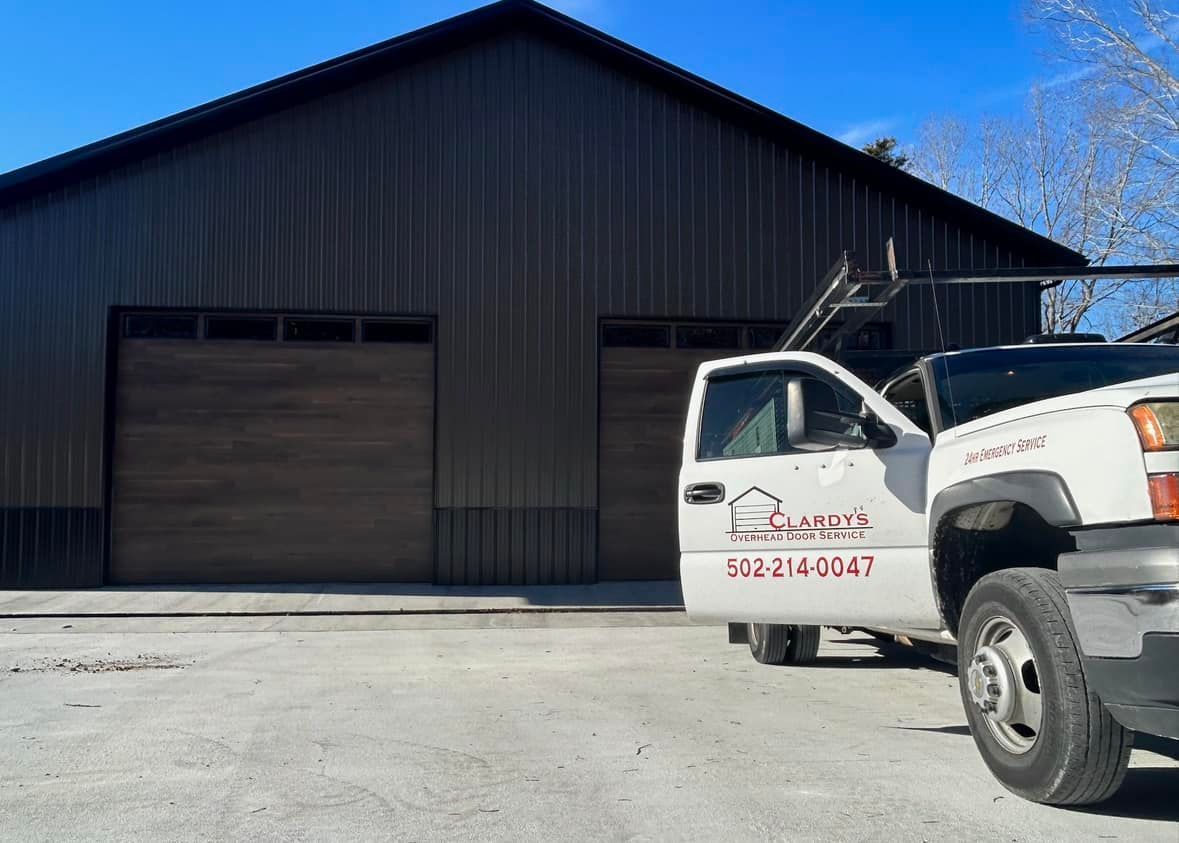 A white truck is parked in front of a large building.