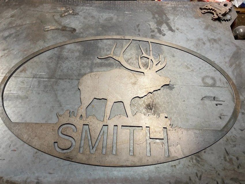 Metal sign with elk silhouette and 