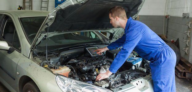 mechanic checking car's engine