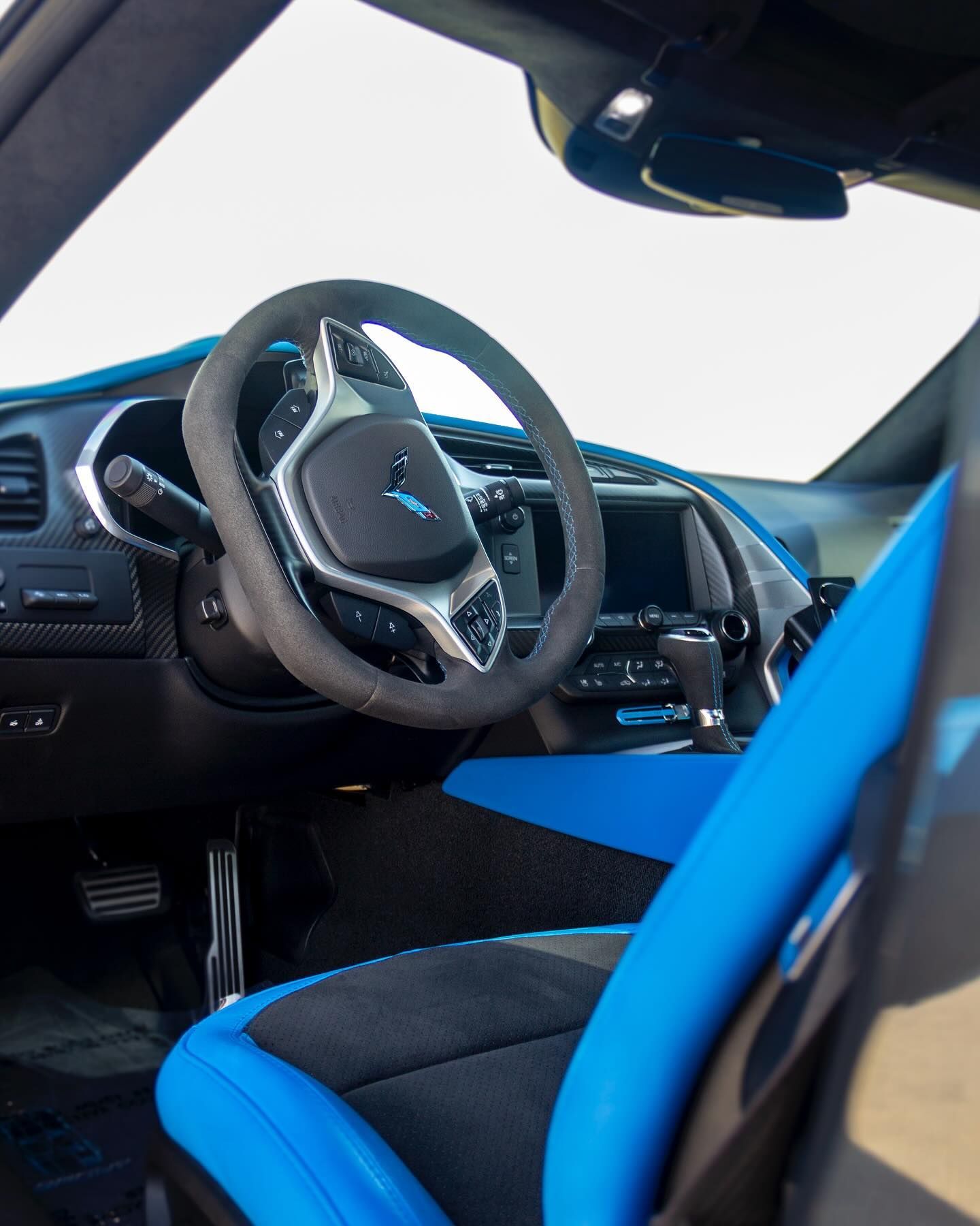 A car with blue seats and a black steering wheel