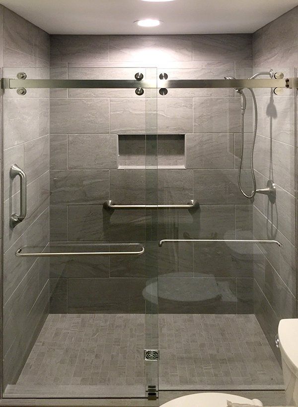 Frameless shower enclosure