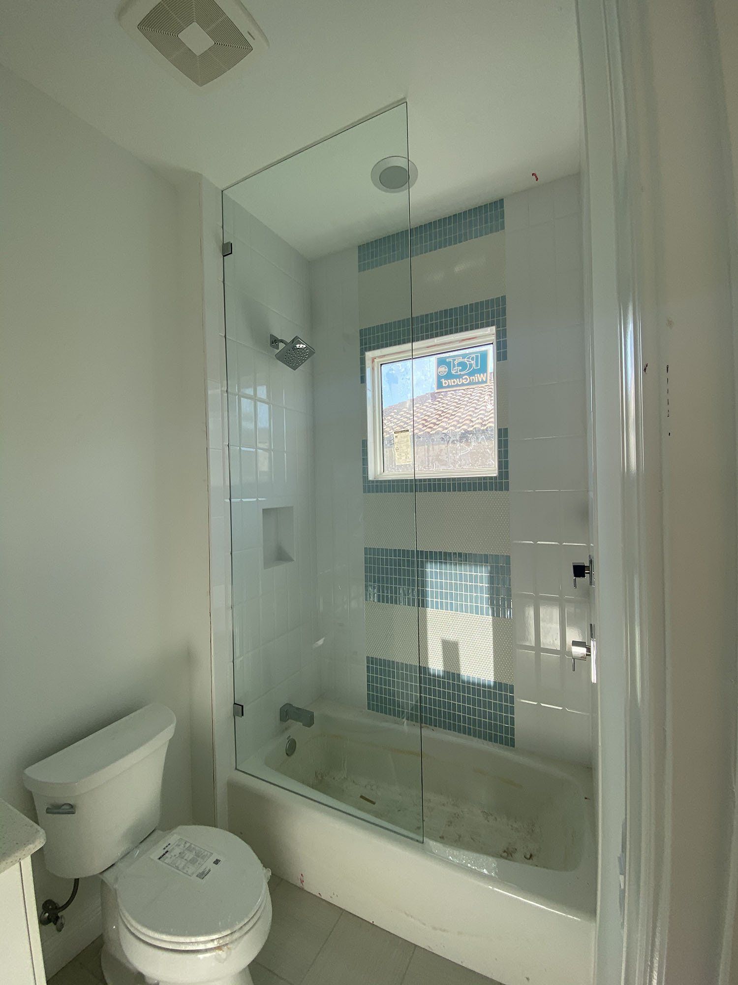 Frameless shower enclosure