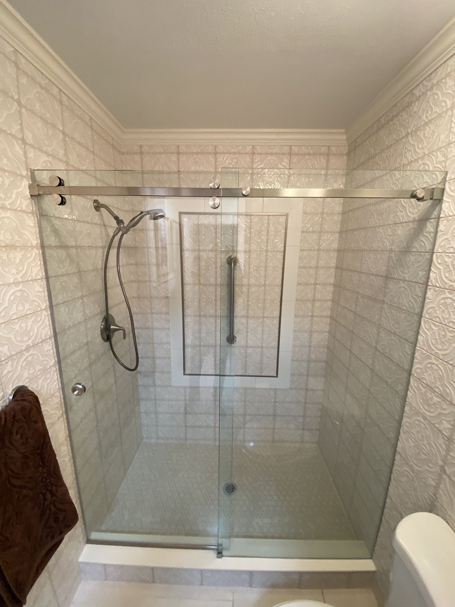 Frameless shower enclosure