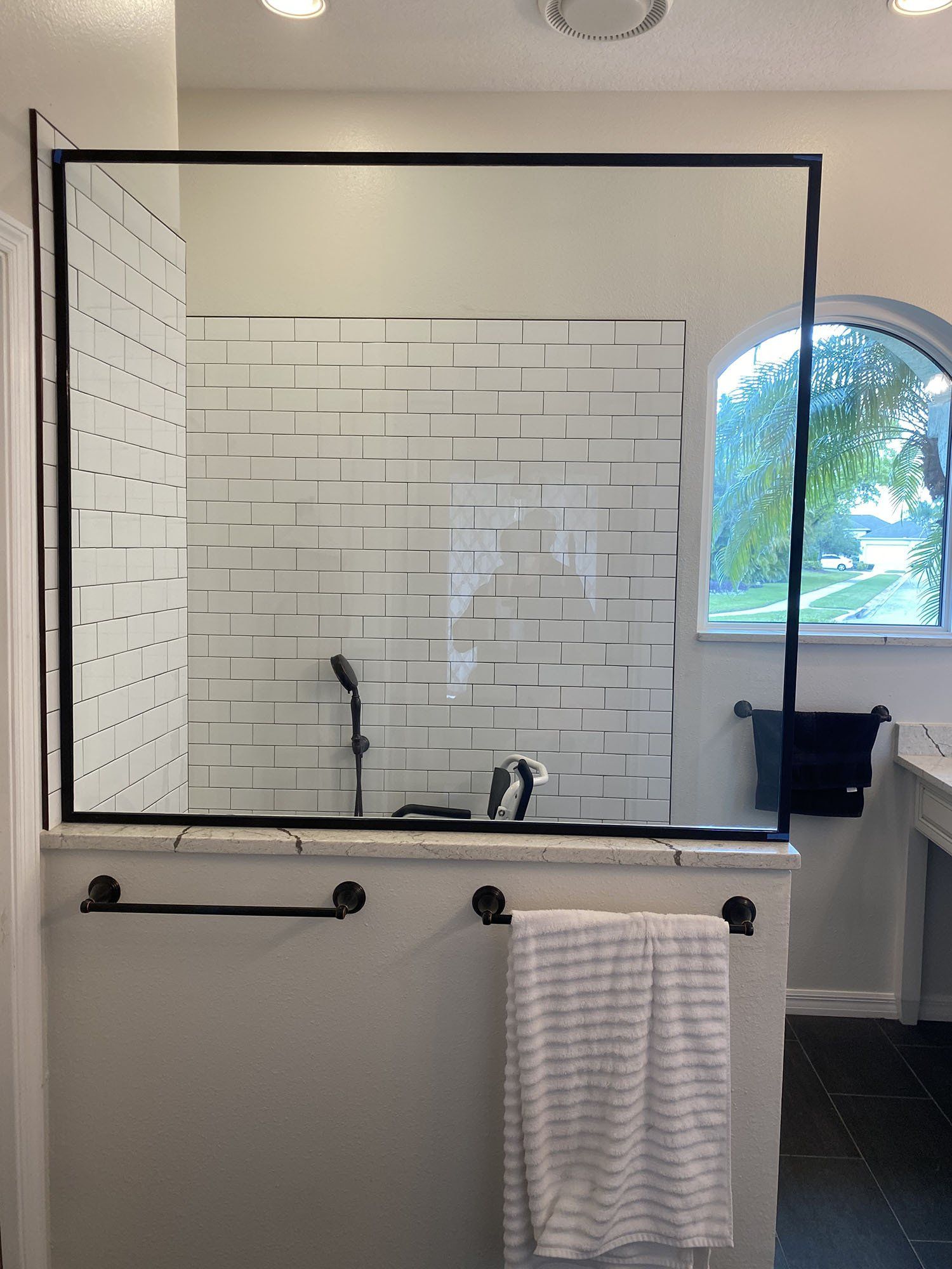 Frameless shower enclosure