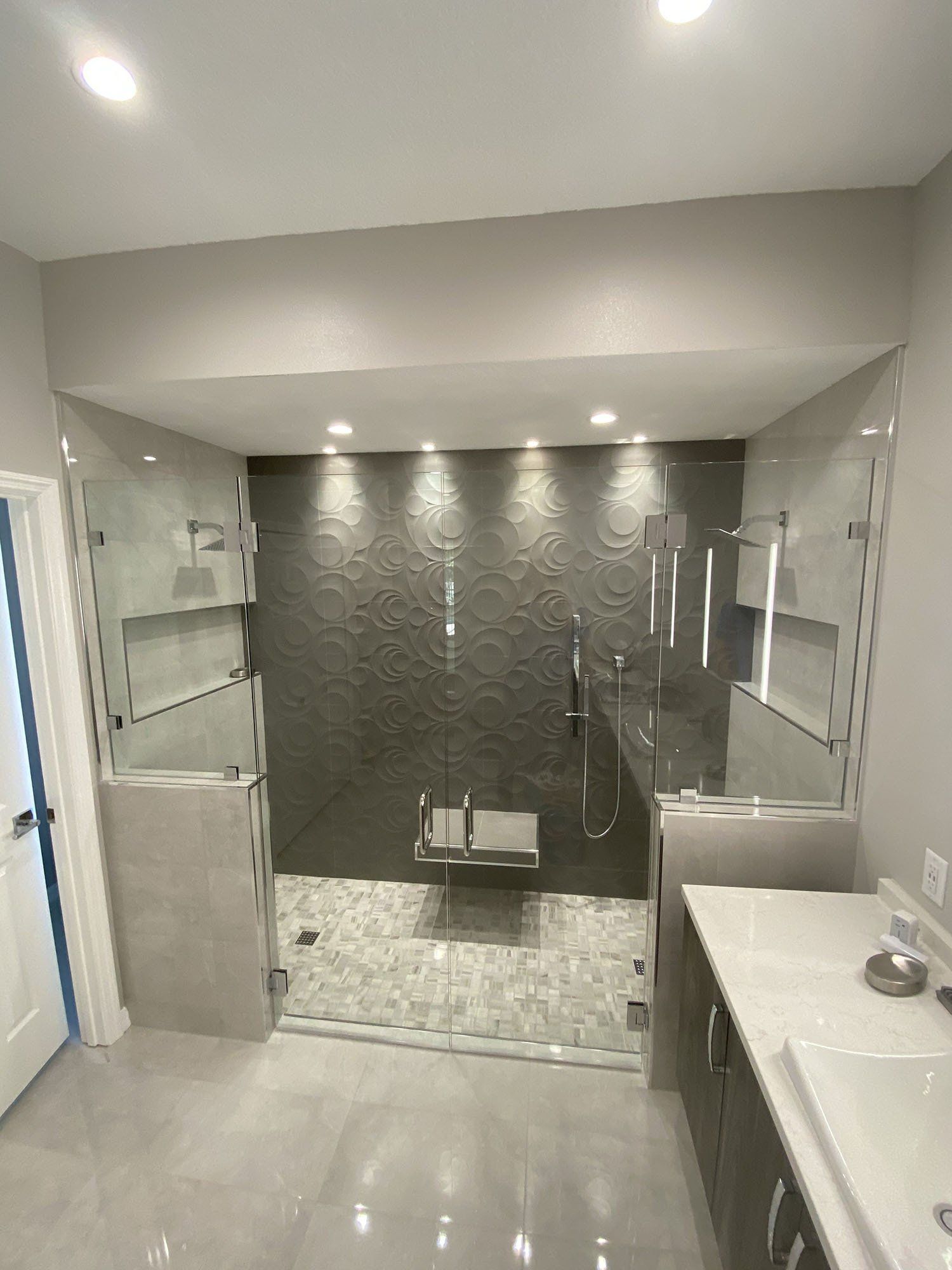 Frameless shower enclosure