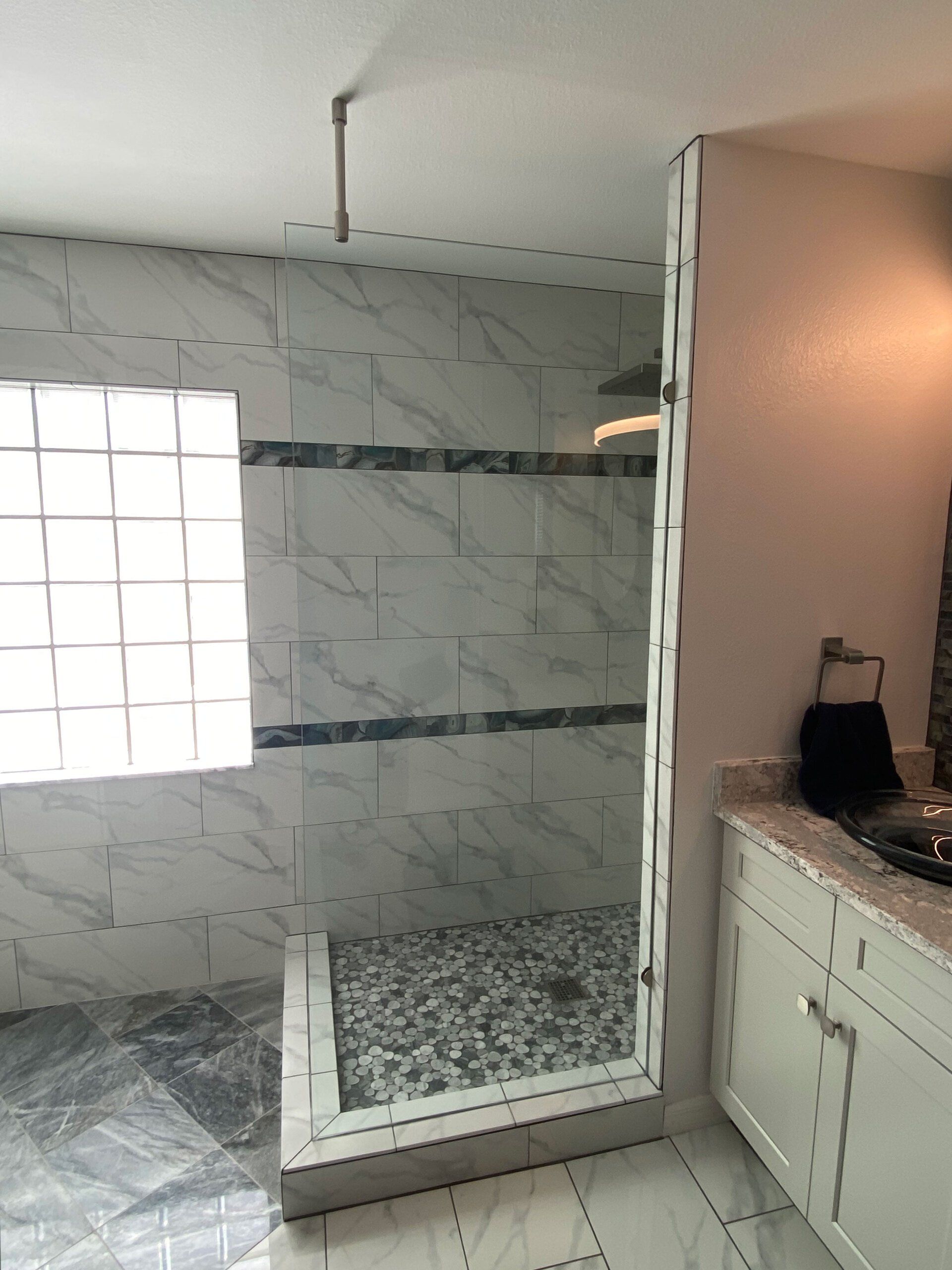 Frameless shower enclosure